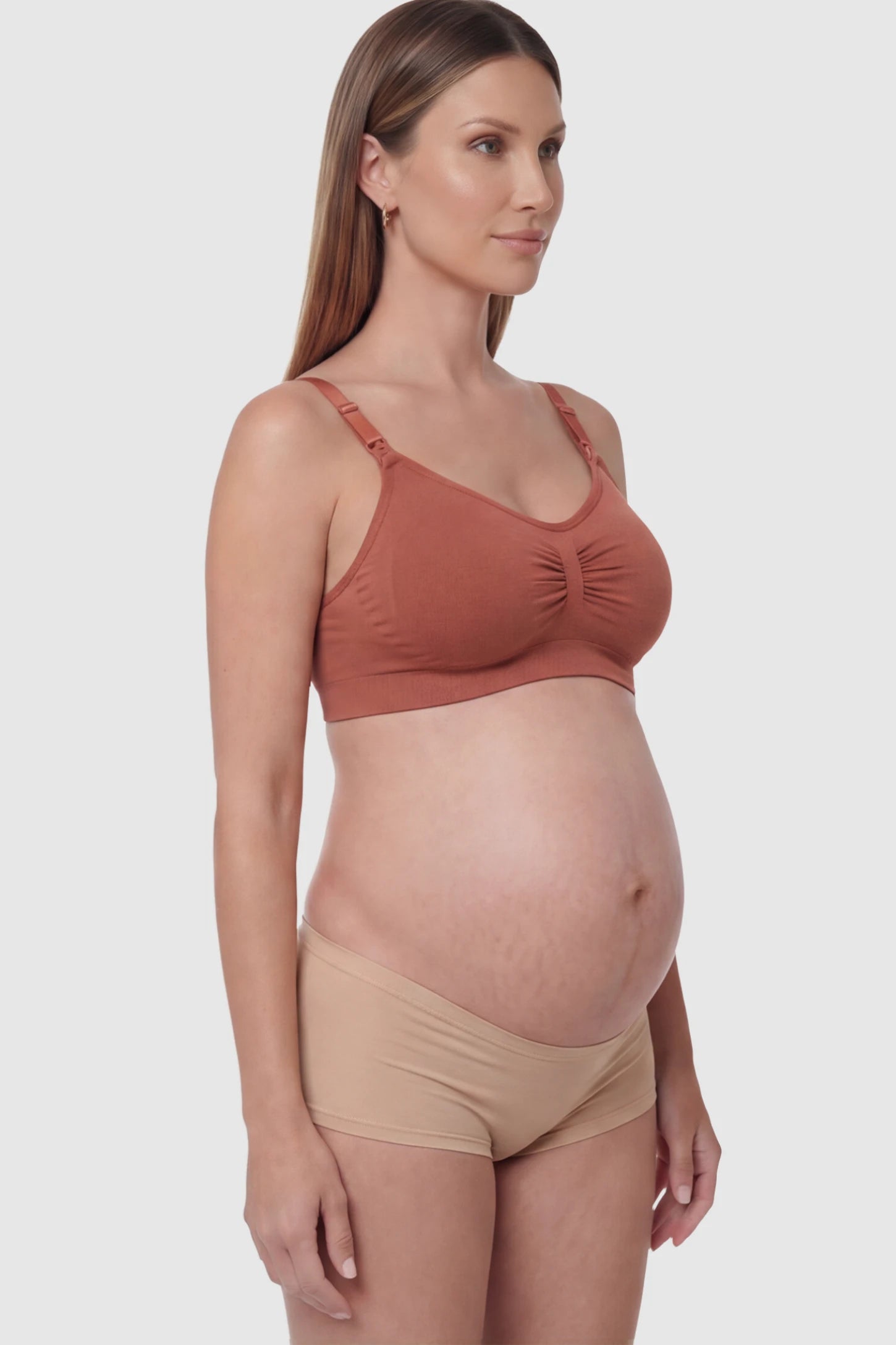 Seamless Ruched Front Wireless Maternity Nursing Bra Seamless Ruched Wireless Nursing Bra in Wine Red with one-handed clips and adaptive stretch on a pregnant model.
