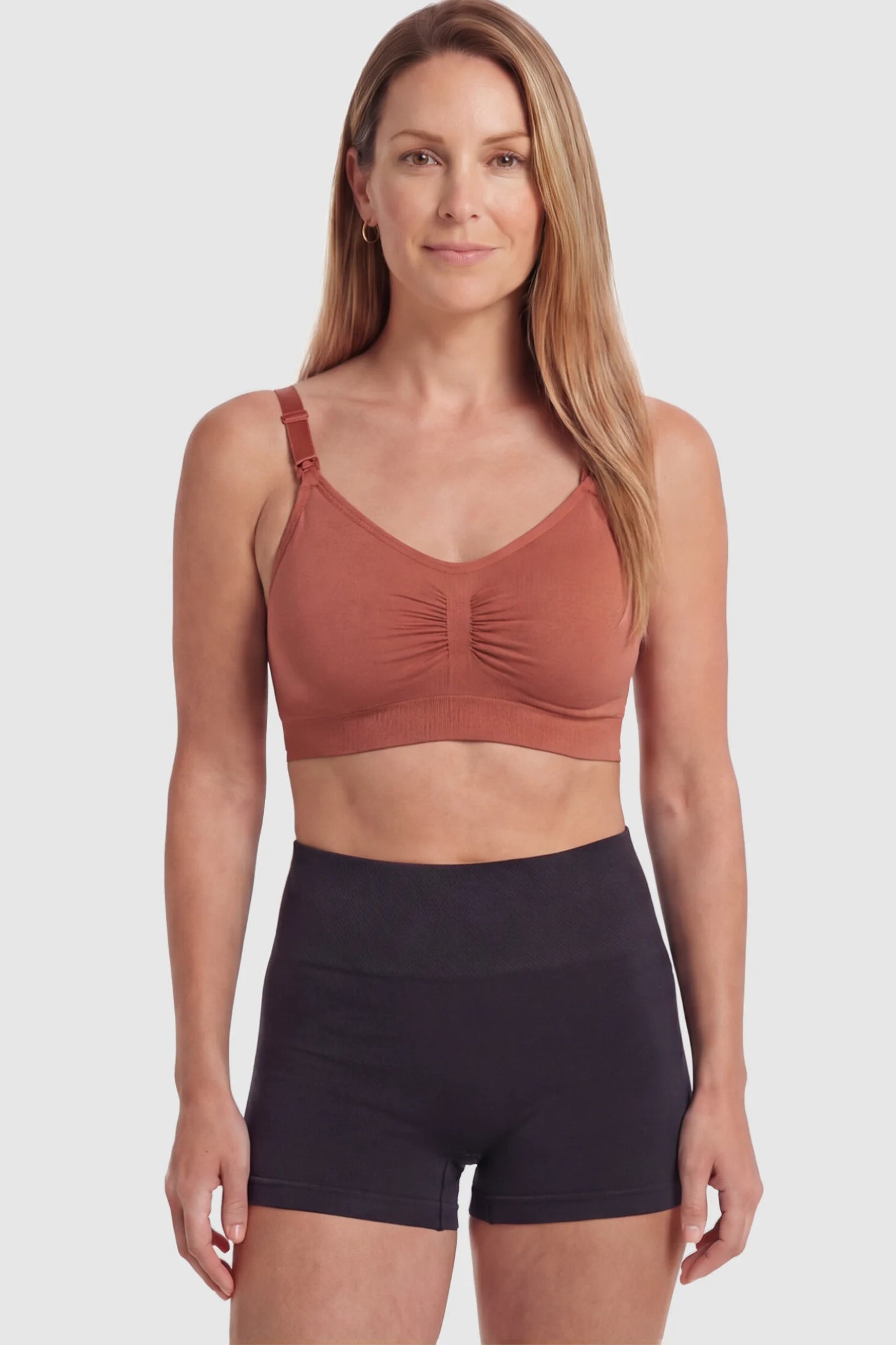 Seamless Ruched Front Wireless Maternity Nursing Bra Seamless Ruched Wireless Nursing Bra in Wine Red with one-handed clips and adaptive stretch on a postpartum model.