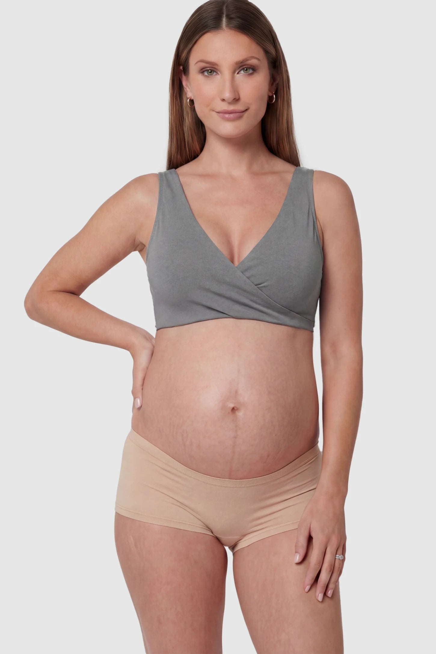 Cotton Blend Crossover Maternity Nursing Bra Cotton Blend Crossover Maternity Nursing Bra in Dark Gray featuring a wire-free wrap front on a pregnant model.