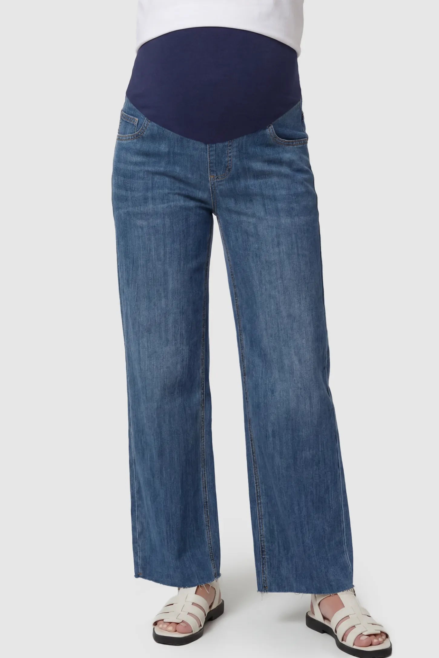 Full Panel Wide Leg Maternity Jeans in Dark Blue featuring a seamless tummy-support band on a pregnant model facing front.