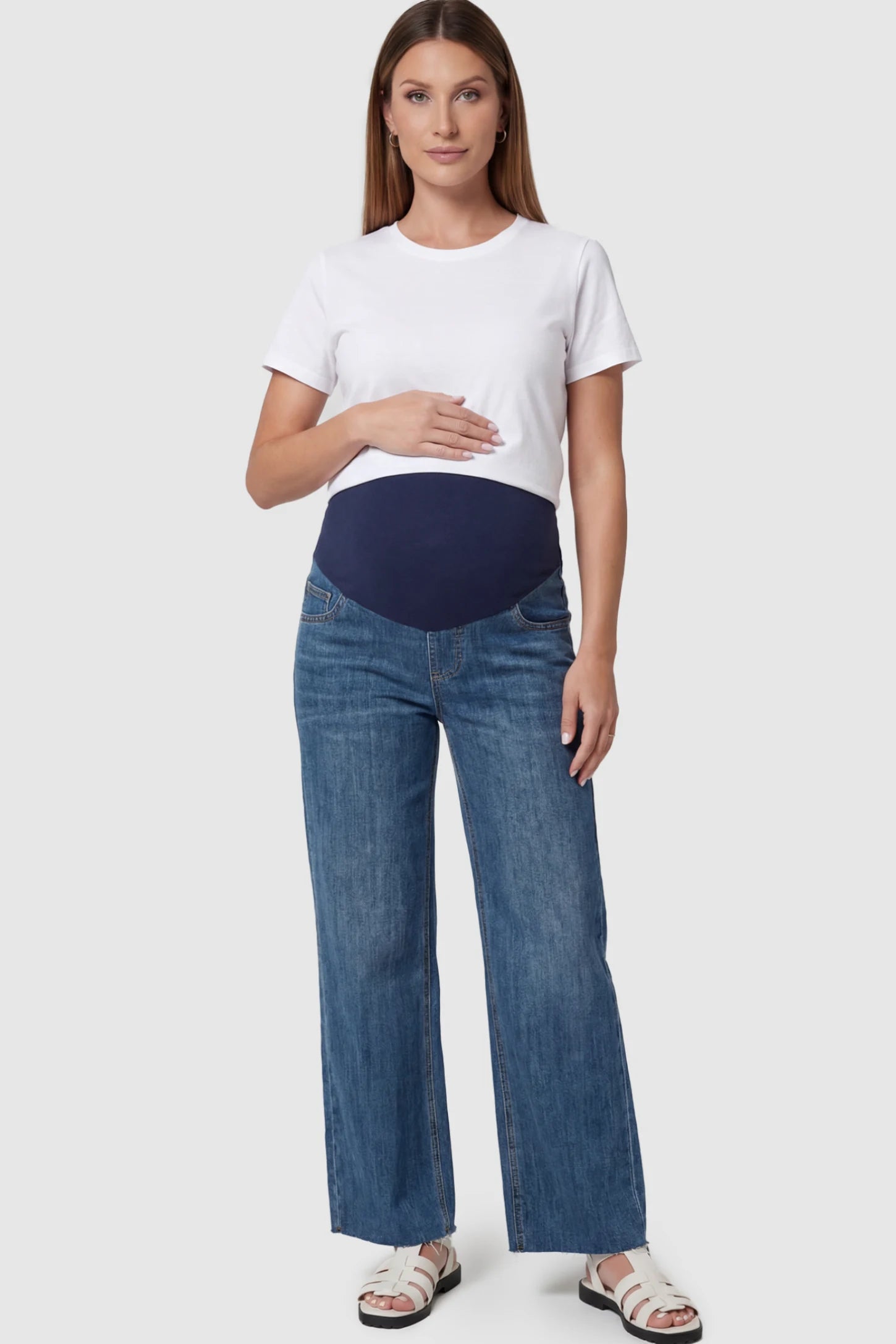 Full Panel Wide Leg Maternity Jeans in Dark Blue featuring a seamless tummy-support band on a pregnant model facing front.