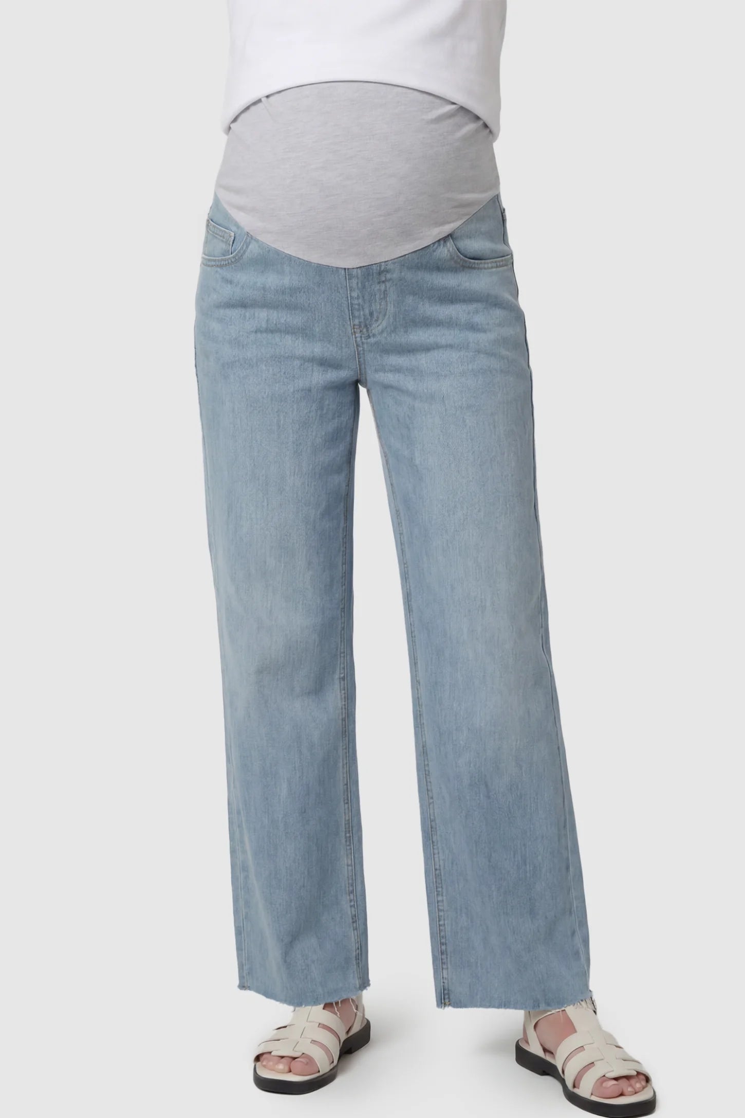 Full Panel Wide Leg Maternity Jeans Full Panel Wide Leg Maternity Jeans in Light Blue featuring a seamless tummy-support band on a pregnant model facing front.