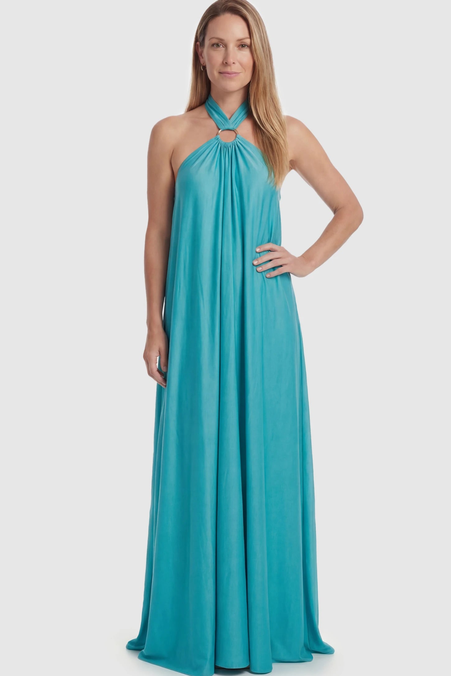 Solid Halter Neck Maternity Maxi Dress Solid Halter Neck Maternity Maxi Dress in Blue featuring a flowing skirt on a postpartum model.