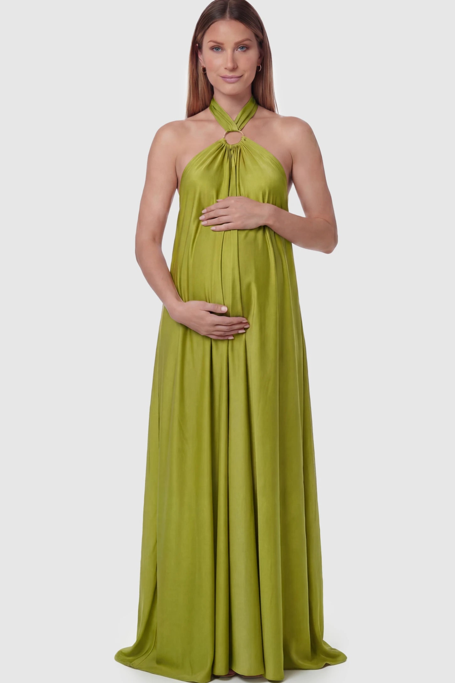 Solid Halter Neck Maternity Maxi Dress Solid Halter Neck Maternity Maxi Dress in Green featuring a flowing skirt on a pregnant model.