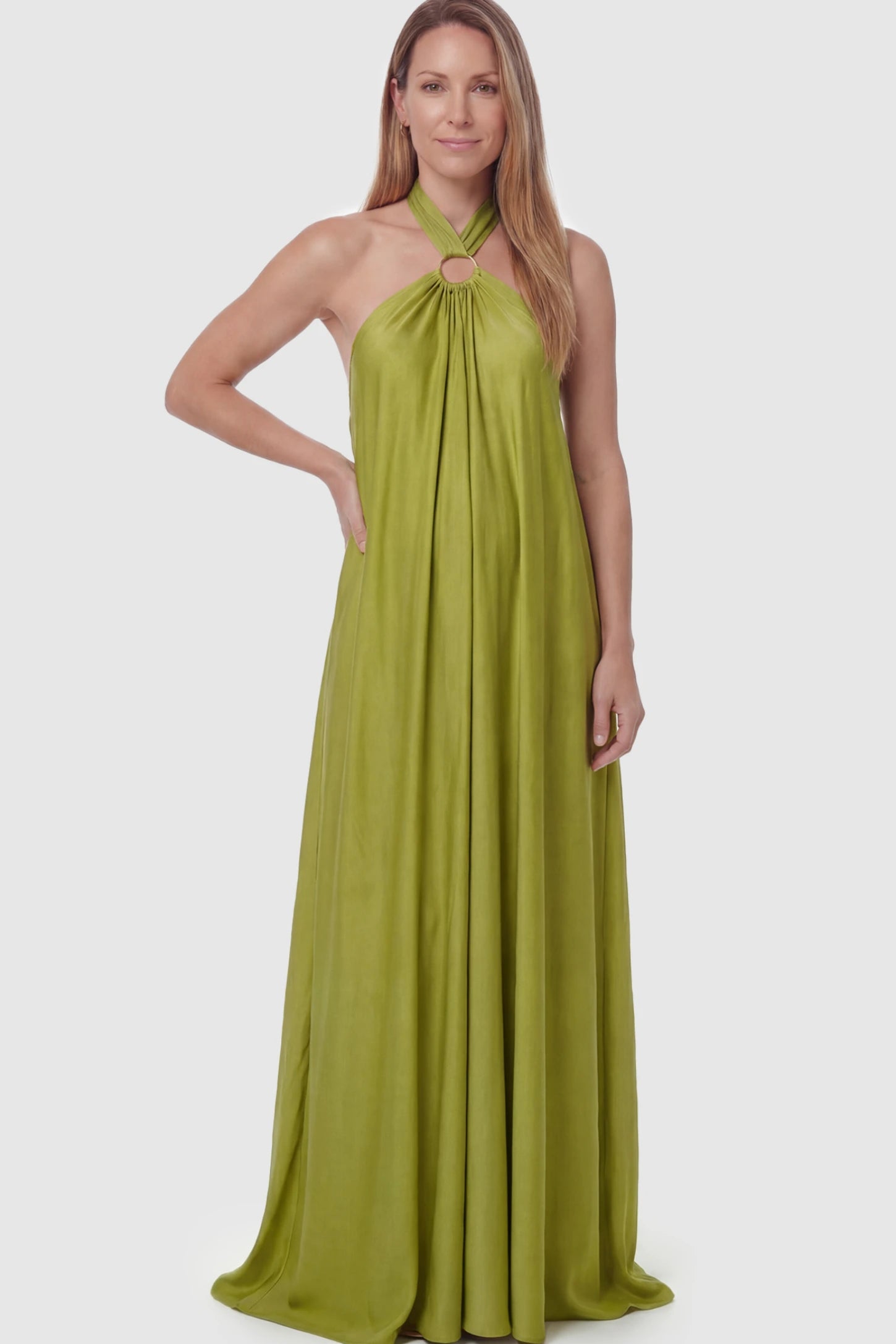 Solid Halter Neck Maternity Maxi Dress Solid Halter Neck Maternity Maxi Dress in Green featuring a flowing skirt on a postpartum model.