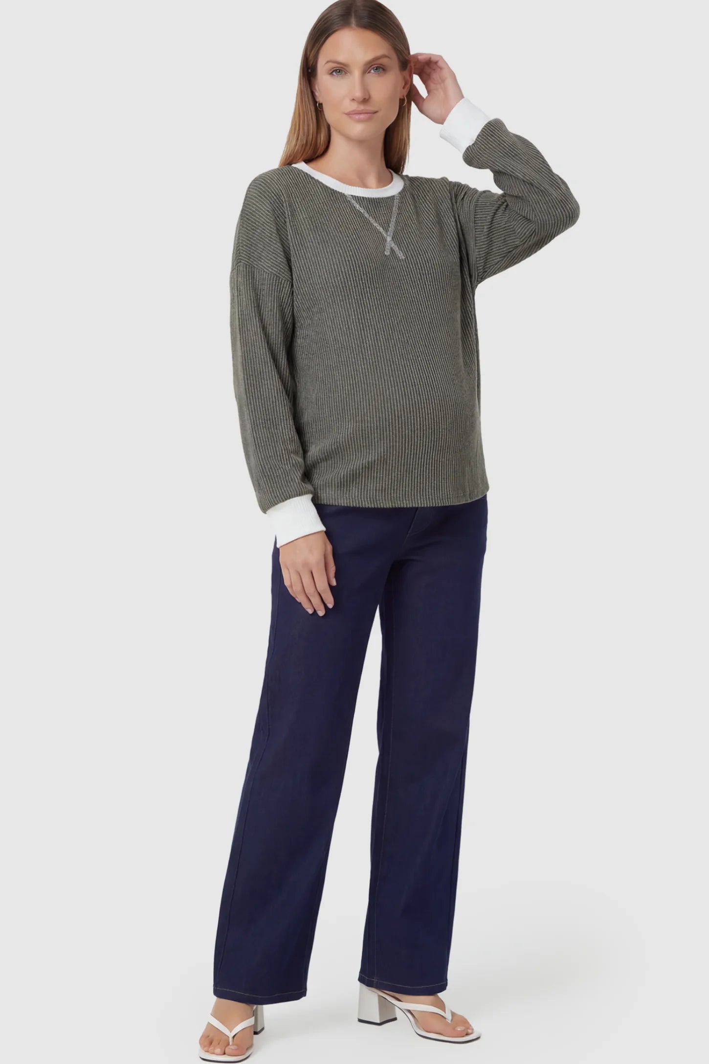 Full Panel Relaxed Wide Leg Maternity Jeans Full Panel Wide-Leg Maternity Jeans in Blue featuring a belly panel on a pregnant model.