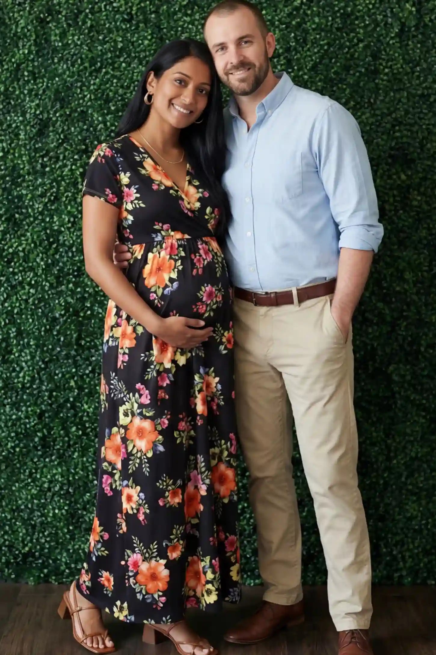 Floral Print V-Neck Maternity Maxi Dress Floral Print V-Neck Maternity Maxi Dress in Black featuring a vibrant floral pattern on a pregnant model.