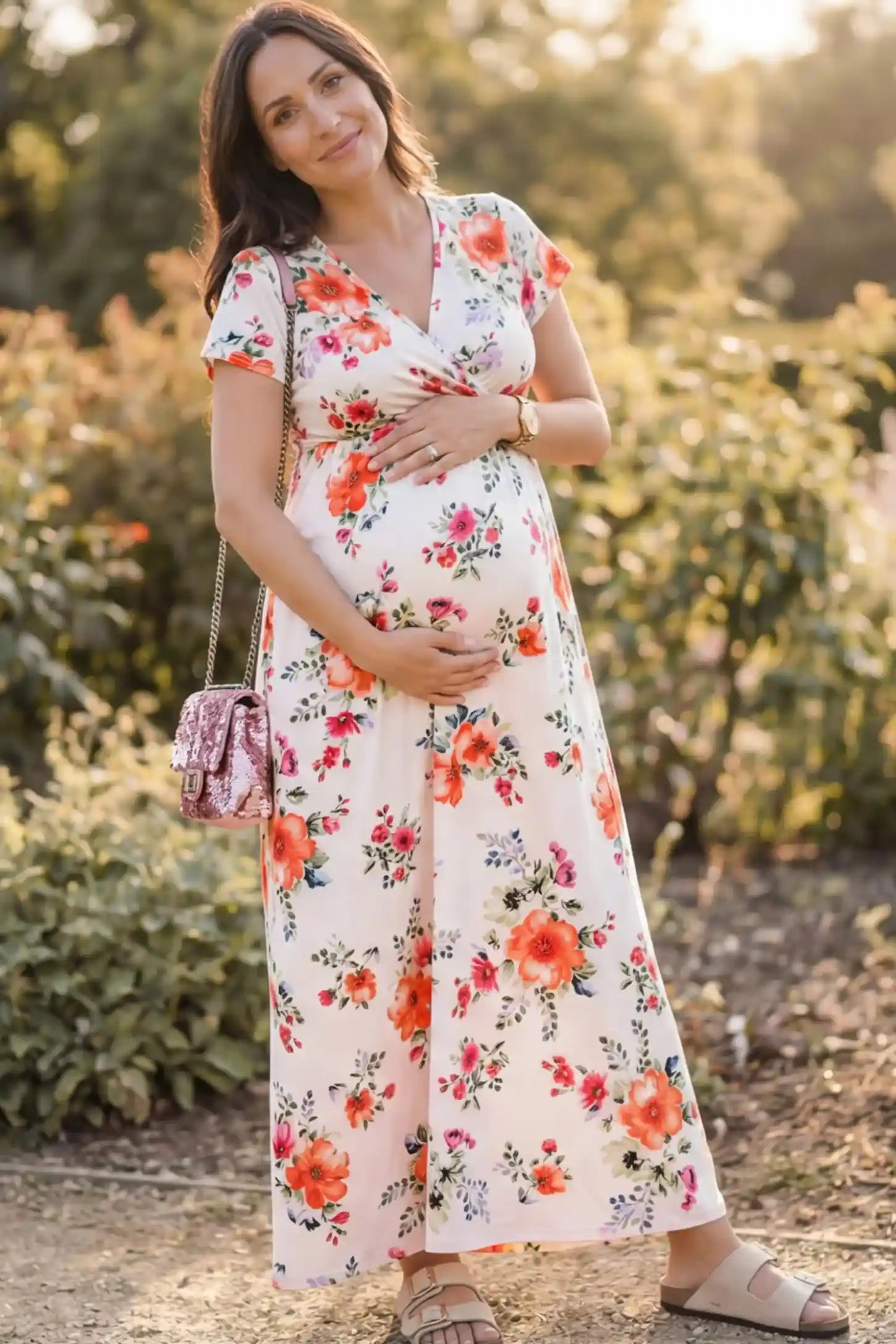 Floral Print V-Neck Maternity Maxi Dress Floral Print V-Neck Maternity Maxi Dress in White featuring a vibrant floral pattern on a pregnant model.