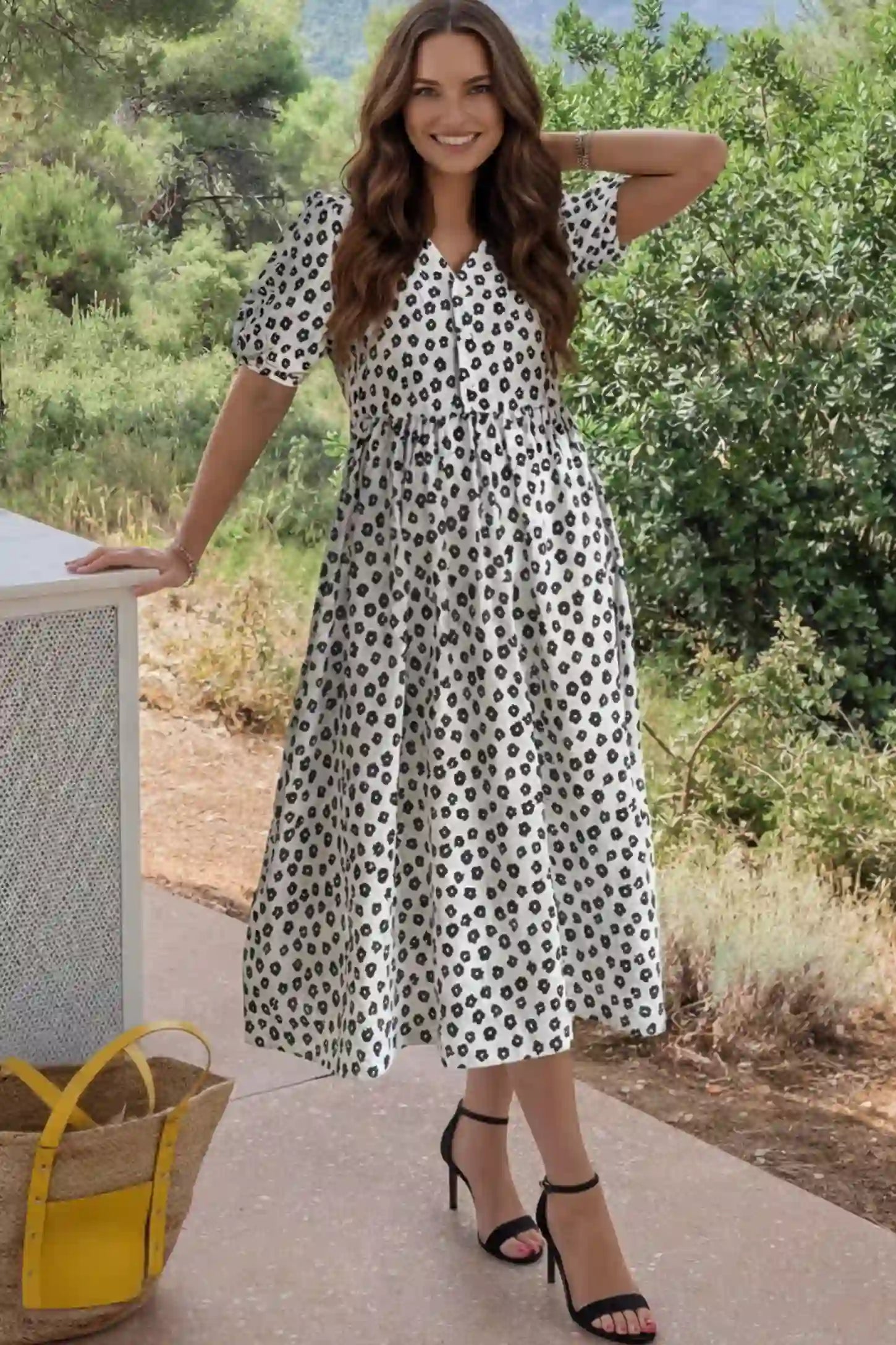 Floral V-Neck Short Sleeve Maternity Nursing Dress Floral Print V-Neck Maternity Nursing Dress in Black featuring functional button-front details on a pregnant model.