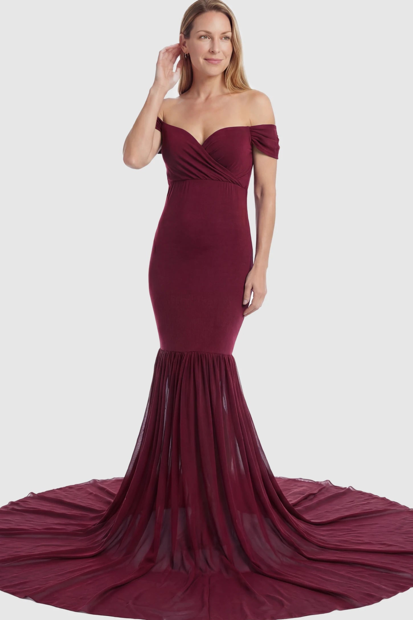 Solid Off Shoulder Mermaid Maternity Photoshoot Gown Off Shoulder Mermaid Maternity Photoshoot Gown in Burgundy featuring a dramatic chiffon train on a postpartum model.