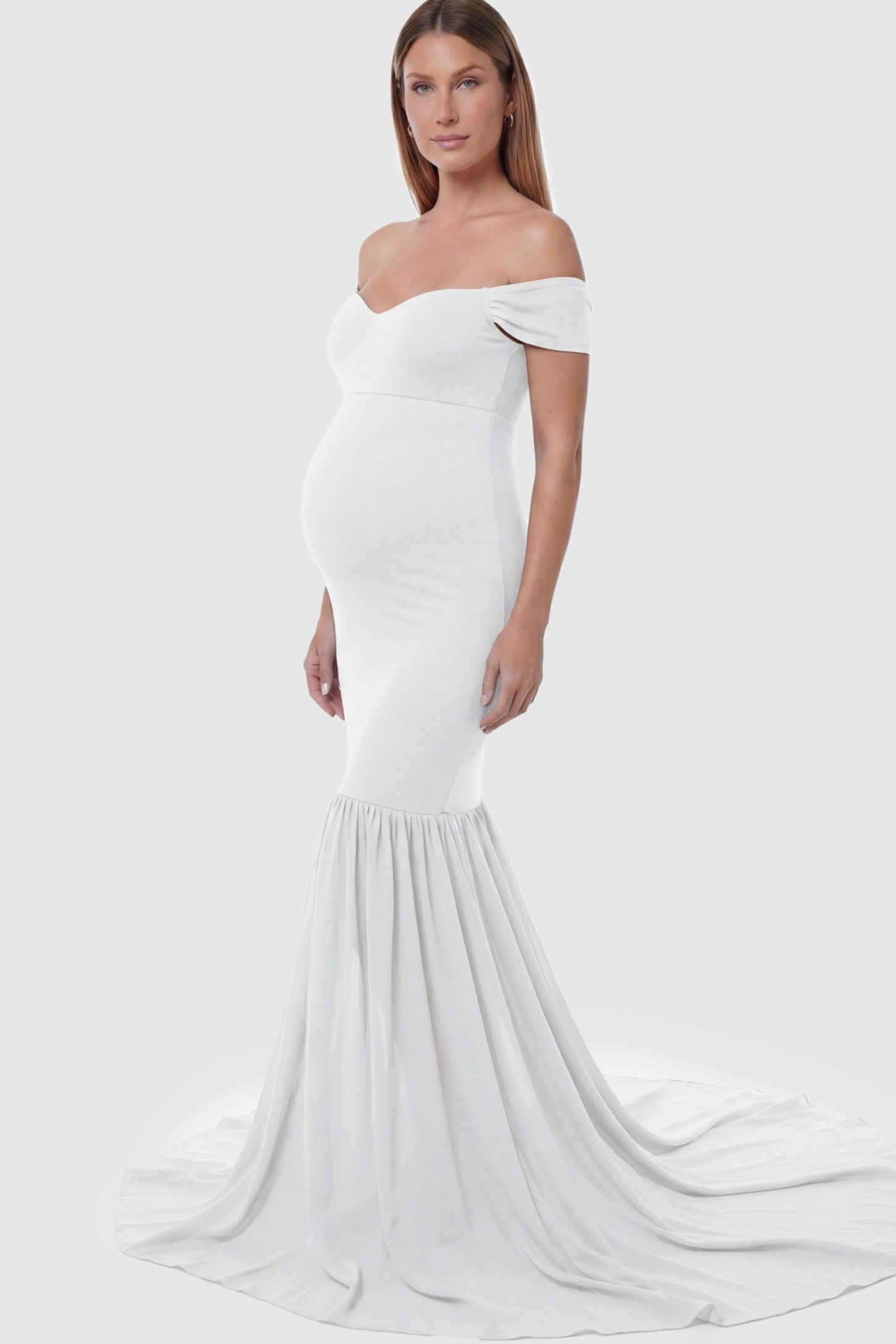 Solid Off Shoulder Mermaid Maternity Photoshoot Gown Off Shoulder Mermaid Maternity Photoshoot Gown in White featuring a dramatic chiffon train on a pregnant model.