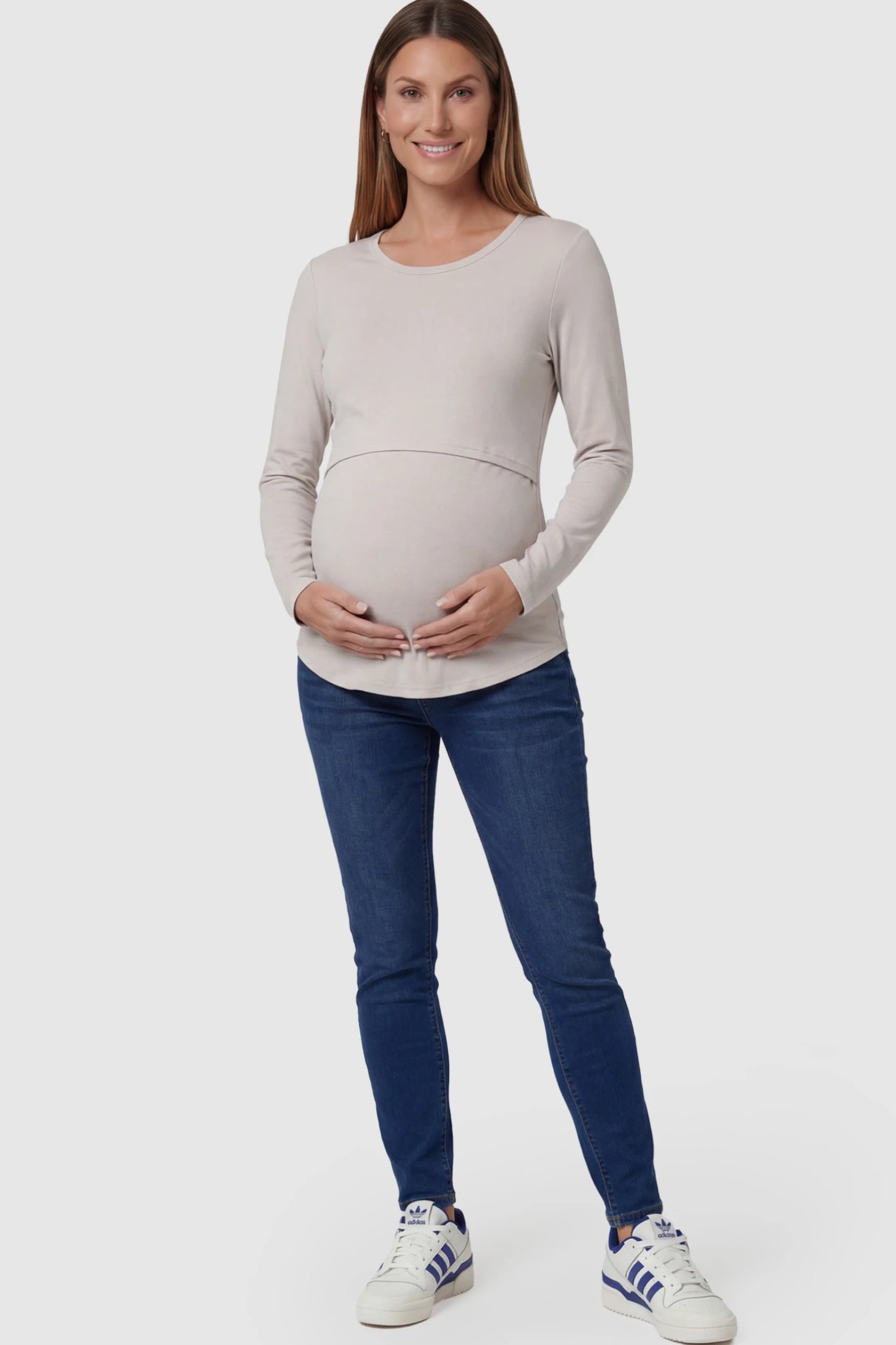 Double Layer Long Sleeve Maternity Nursing Top Double Layer Long Sleeve Maternity & Nursing Top in Light Apricot with a discrete lift-up access on a pregnant model.