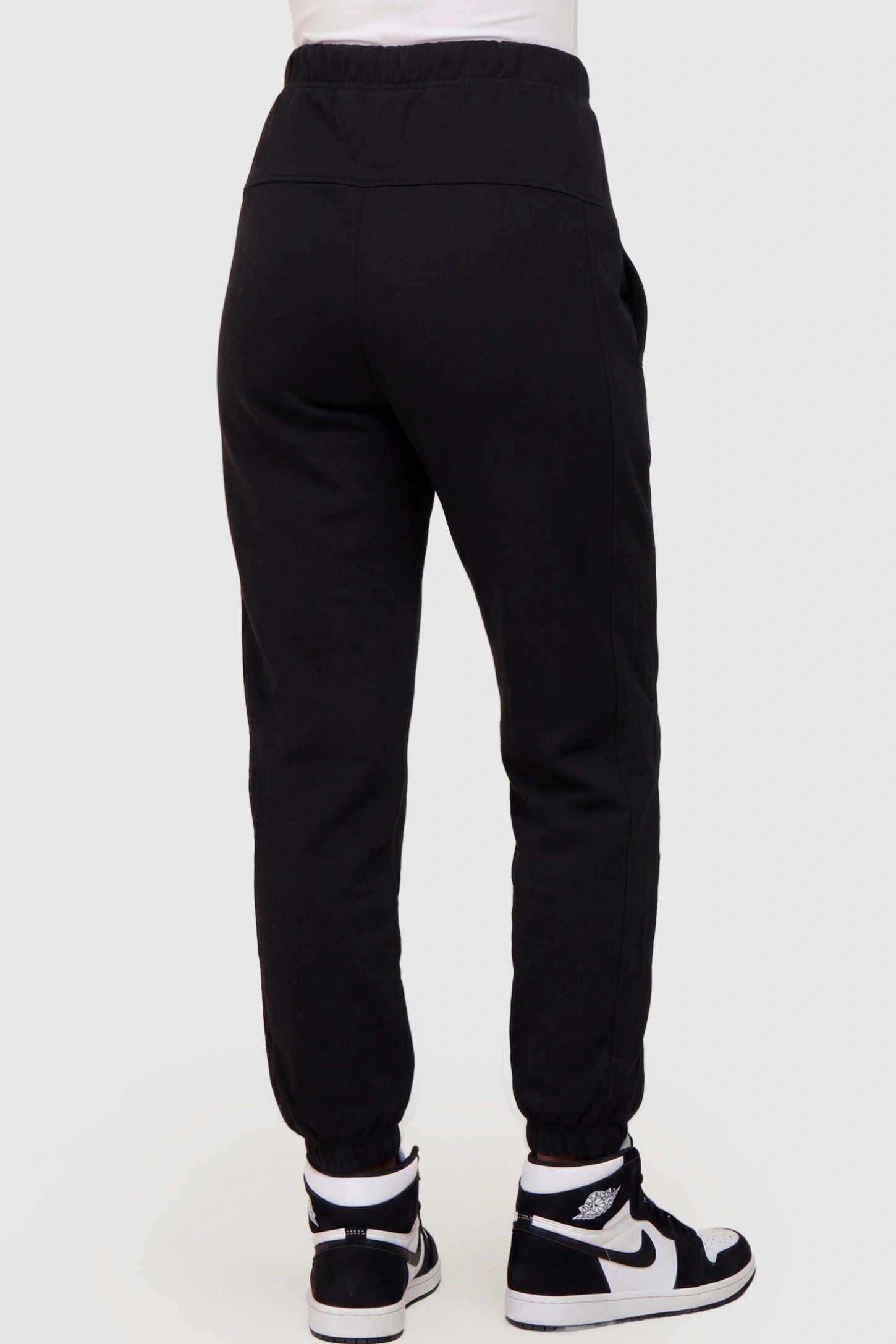 Cotton Blend Full Panel Tapered Leg Maternity Joggers Cotton Blend Full Panel Tapered Leg Maternity Joggers in Black featuring a high-waisted support band on a pregnant model showing back.