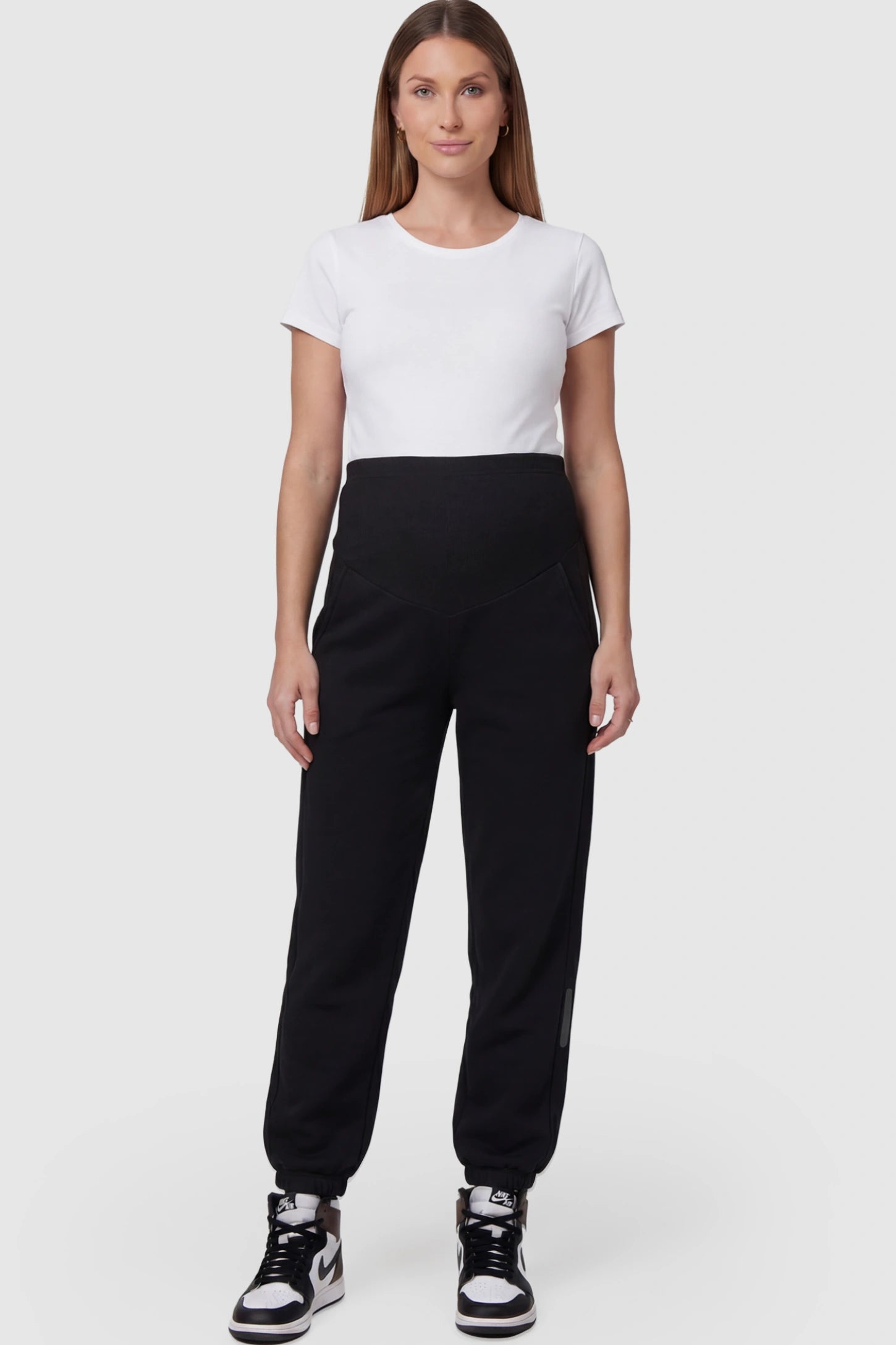 Cotton Blend Full Panel Tapered Leg Maternity Joggers in Black featuring a high-waisted support band on a pregnant model facing front.