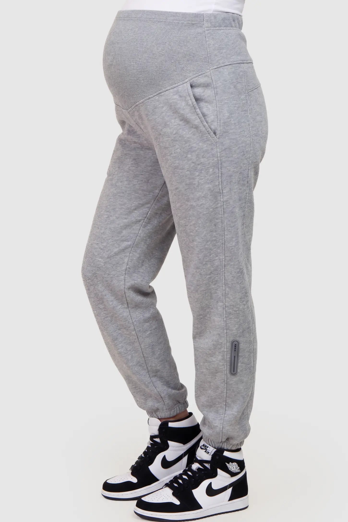 Cotton Blend Full Panel Tapered Leg Maternity Joggers Cotton Blend Full Panel Tapered Leg Maternity Joggers in Gray featuring a high-waisted support band on a pregnant model showing side.