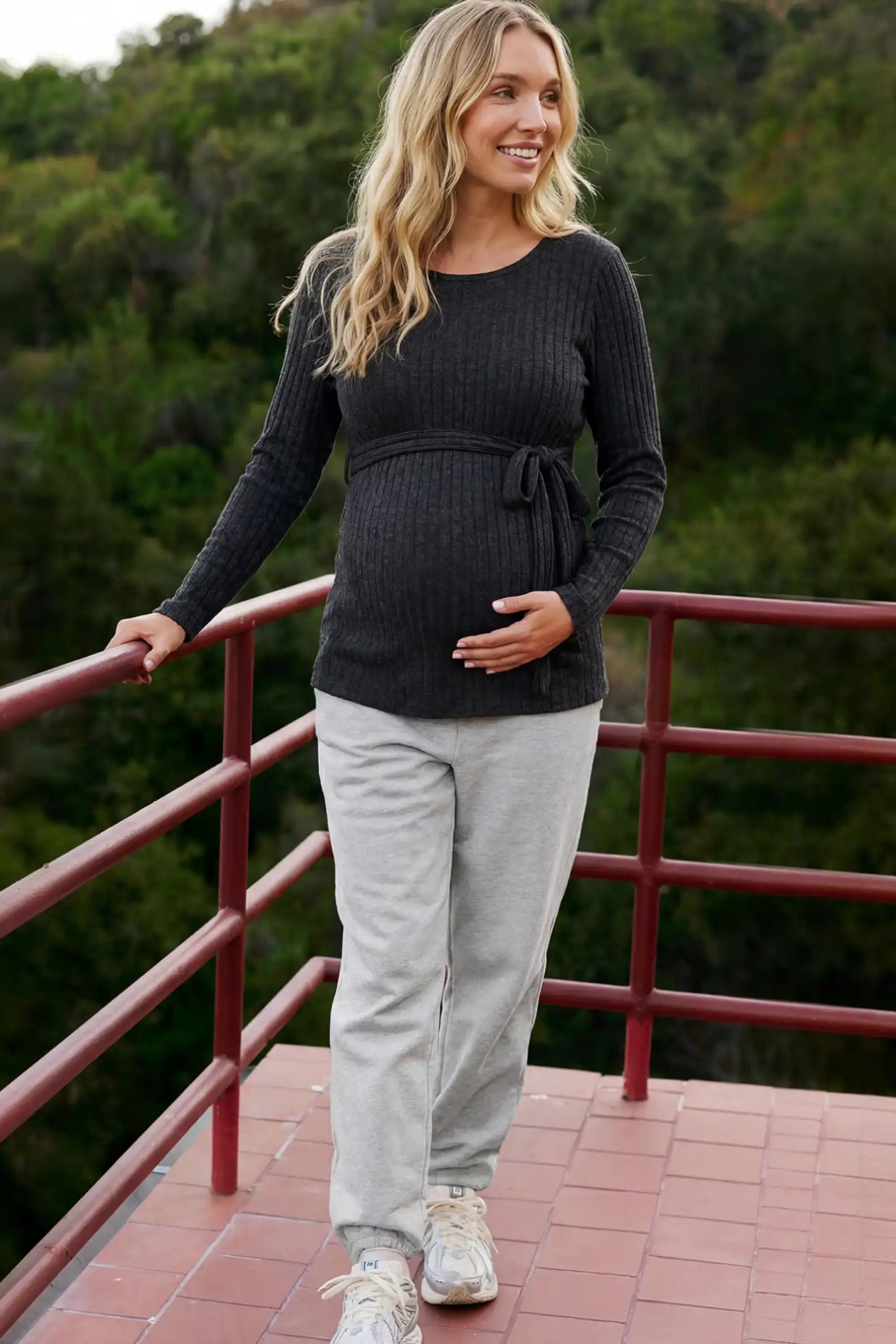 Ribbed Tie-Waist Long Sleeve Maternity Top Ribbed Tie-Waist Long Sleeve Maternity Top in Black featuring an adjustable waist on a pregnant model.