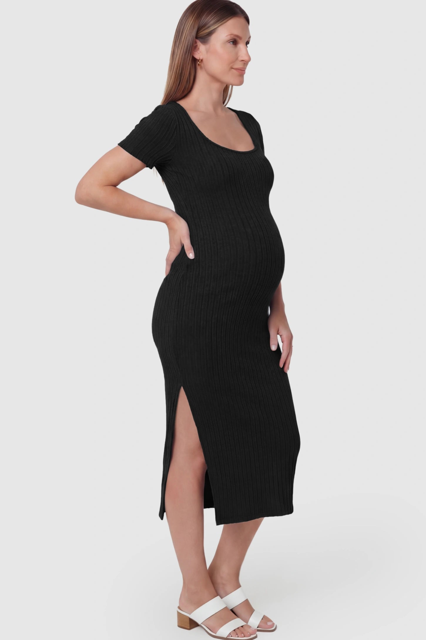 Ribbed Knit Scoop Neck Side Slit Maternity Midi Dress Ribbed Knit Scoop Neck Side Slit Maternity Midi Dress in Black featuring a side slit on a pregnant model.