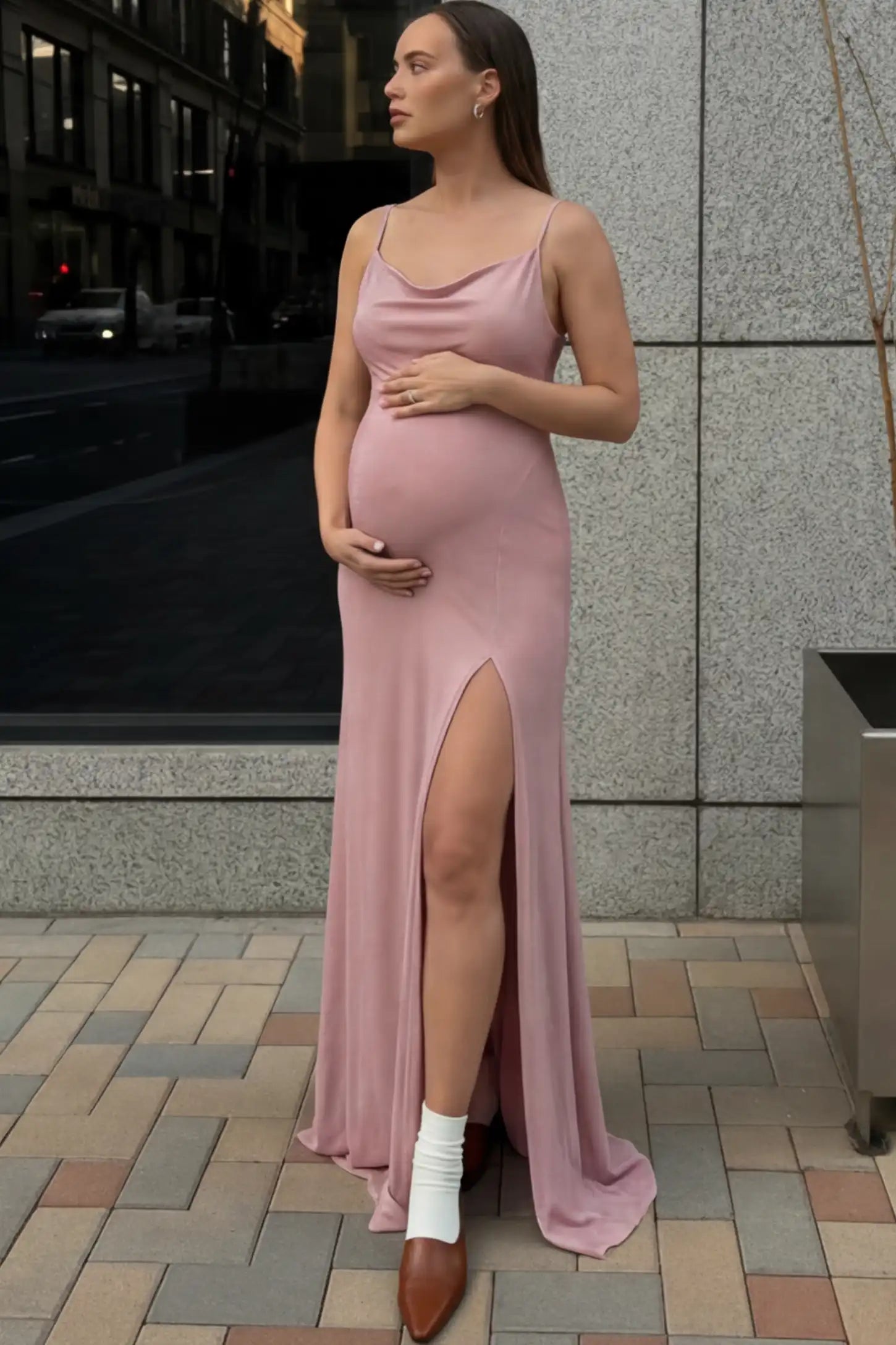 Spaghetti Strap Side Slit Slim Fitting Maternity Maxi Dress in Shimmer Pink featuring a draped neck on a pregnant model.