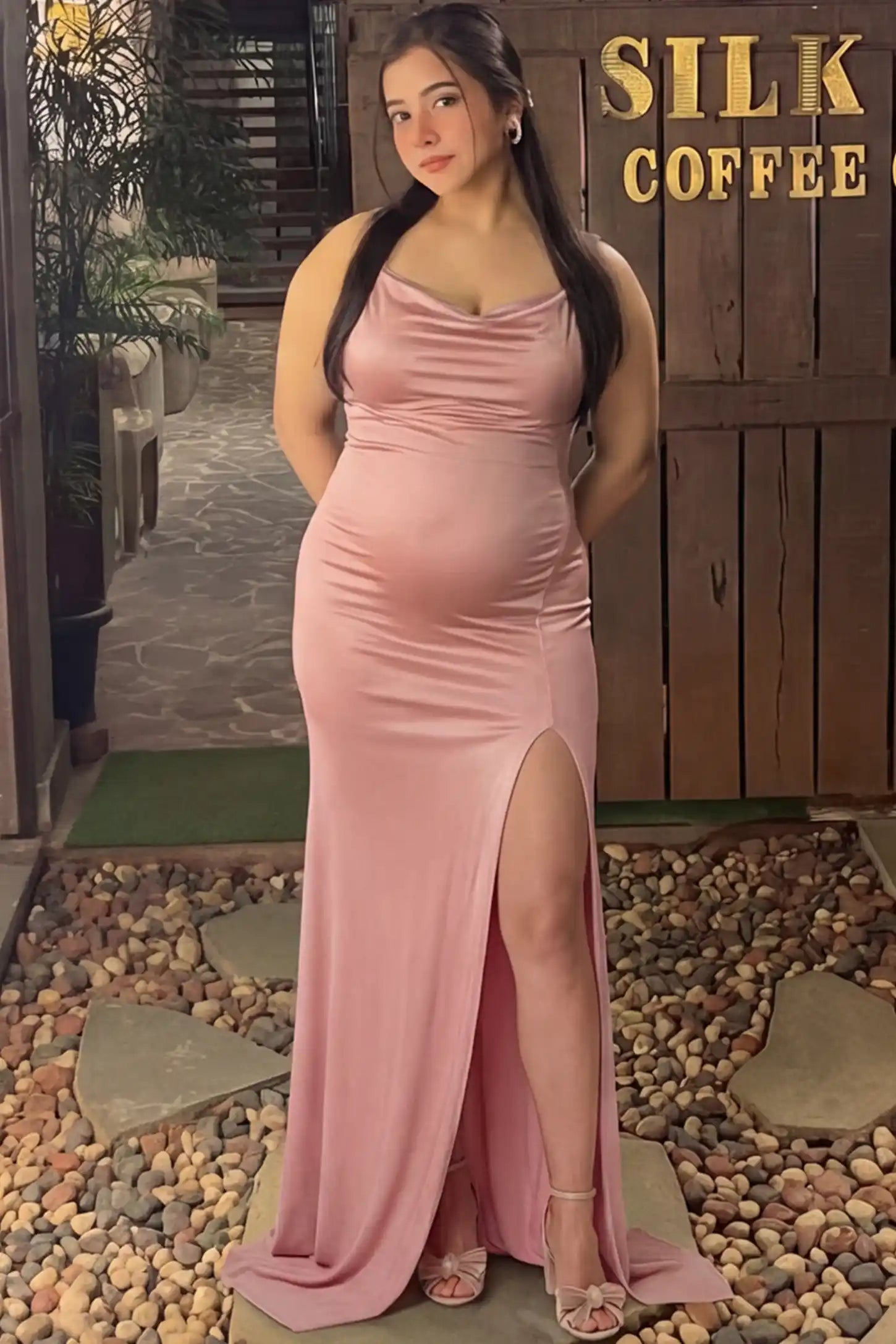 Spaghetti Strap Side Slit Bodycon Maternity Maxi Dress Spaghetti Strap Side Slit Slim Fitting Maternity Maxi Dress in Shimmer Pink featuring a draped neck on a pregnant model.