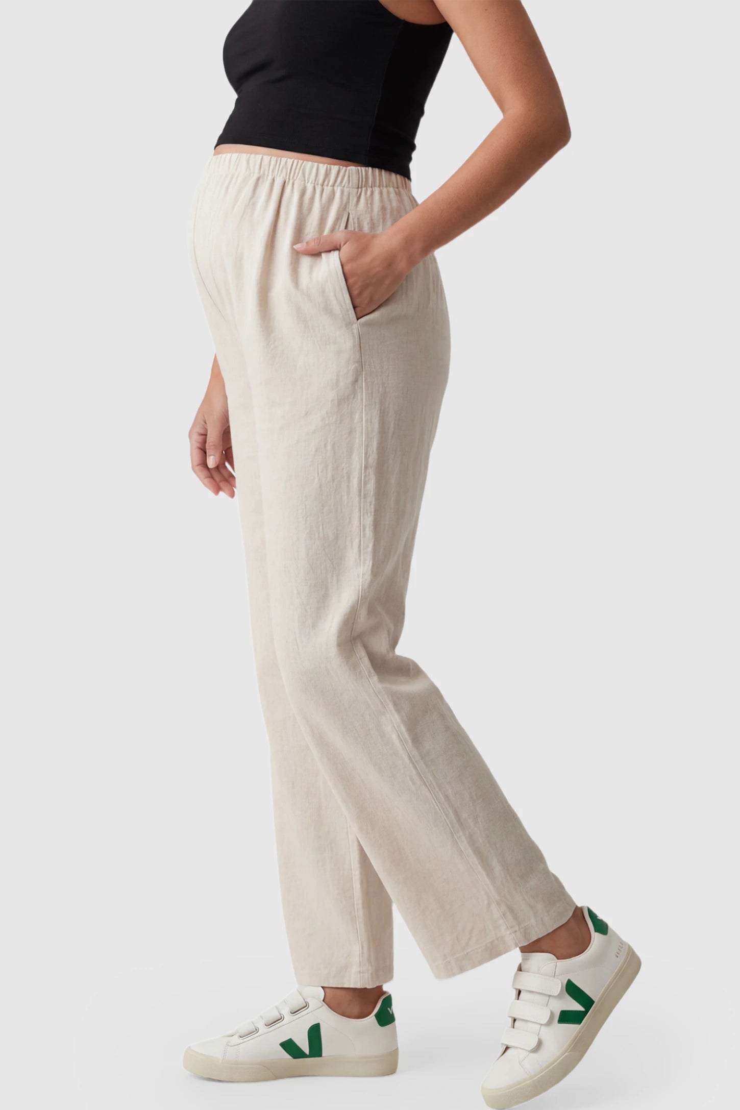 Adjustable Elastic Waist Wide Leg Maternity Pants Adjustable Elastic Waist Wide-Leg Maternity Pants in Beige featuring a customizable button-hole waistband on a pregnant model showing side.