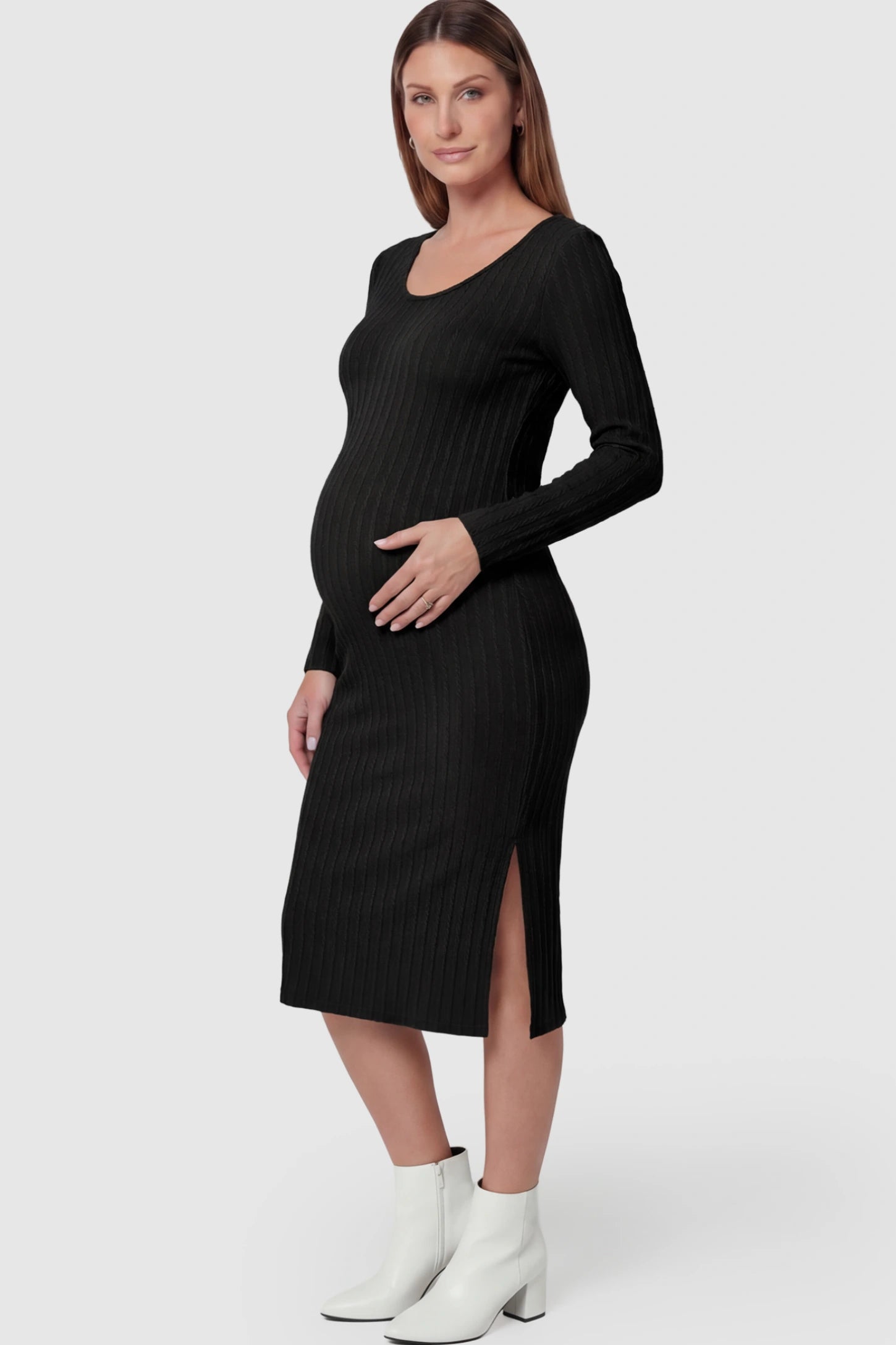 Ribbed Knit Long Sleeve Bodycon Maternity Midi Dress Ribbed Knit Long Sleeve Bodycon Maternity Midi Dress in Black featuring a Side Slit on a pregnant model.