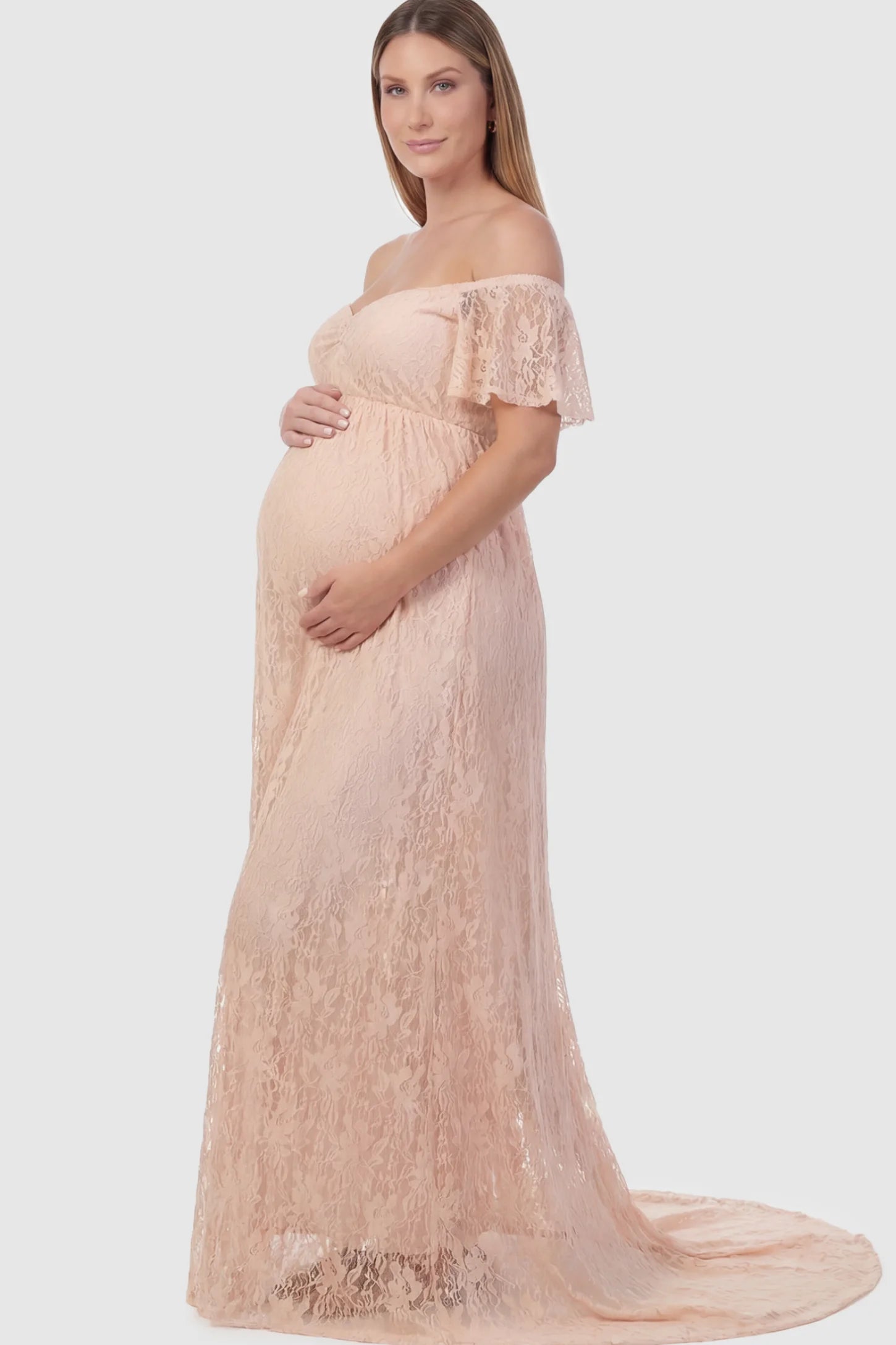 Floral Lace Off Shoulder Maternity Maxi Dress Floral Lace Off The Shoulder Maternity Maxi Dress featuring a ruched bust in Pink on a pregnant model.