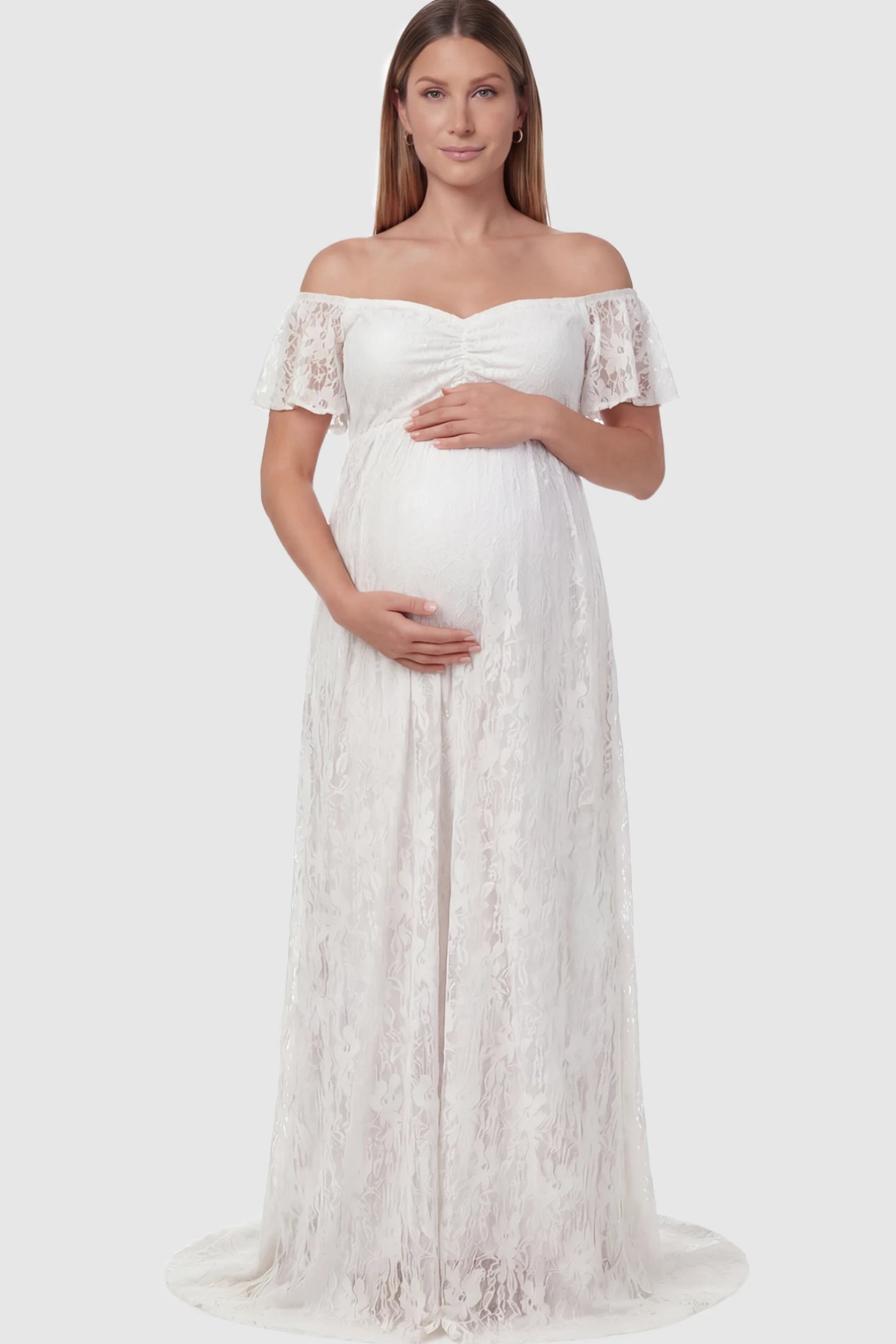 Floral Lace Off Shoulder Maternity Maxi Dress Floral Lace Off The Shoulder Maternity Maxi Dress featuring a ruched bust in White on a pregnant model.