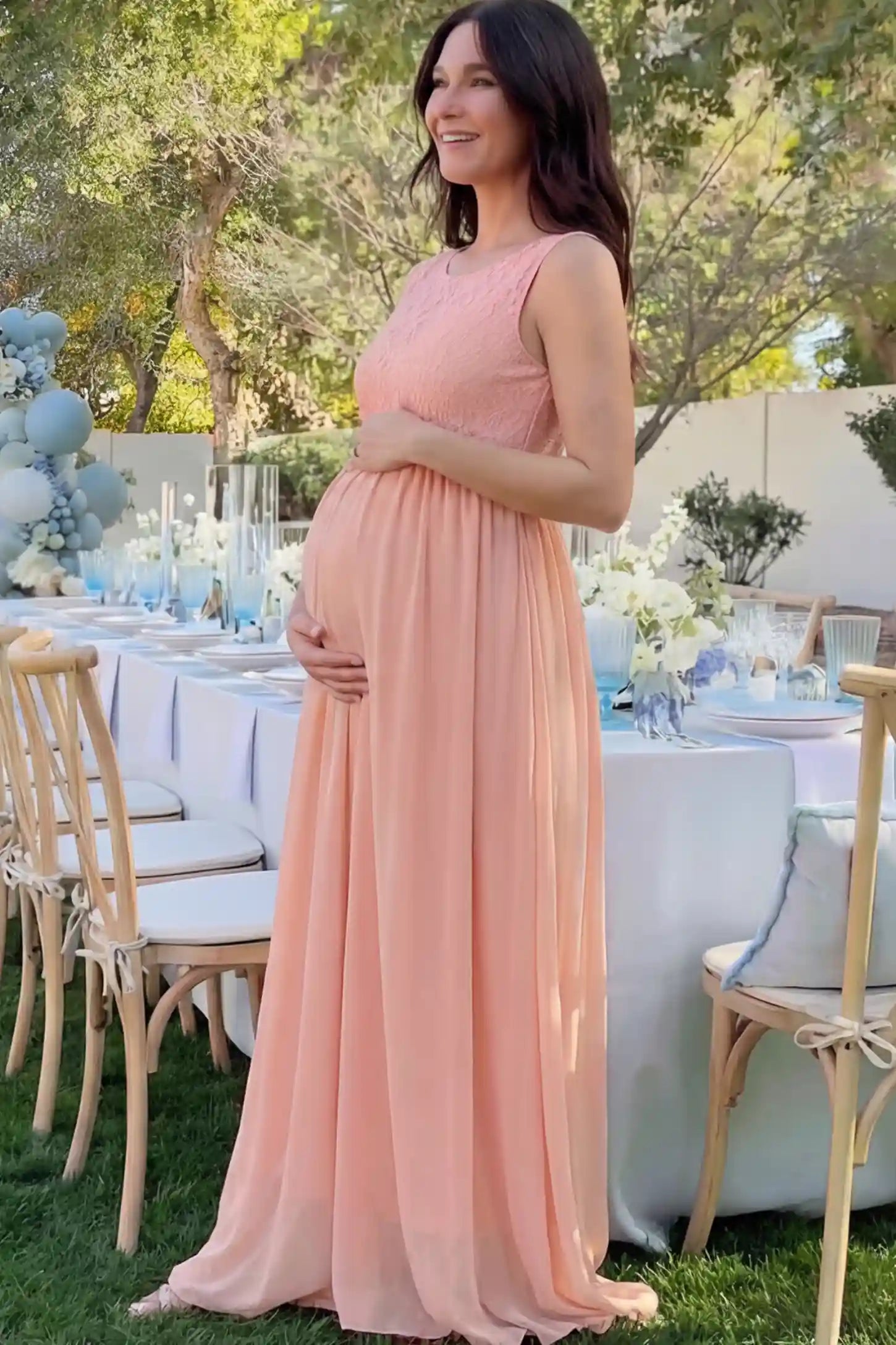 Floral Lace Sleeveless Maternity Maxi Dress Floral Lace Sleeveless Maternity Maxi Dress in Pink featuring a flowing skirt on a pregnant model.