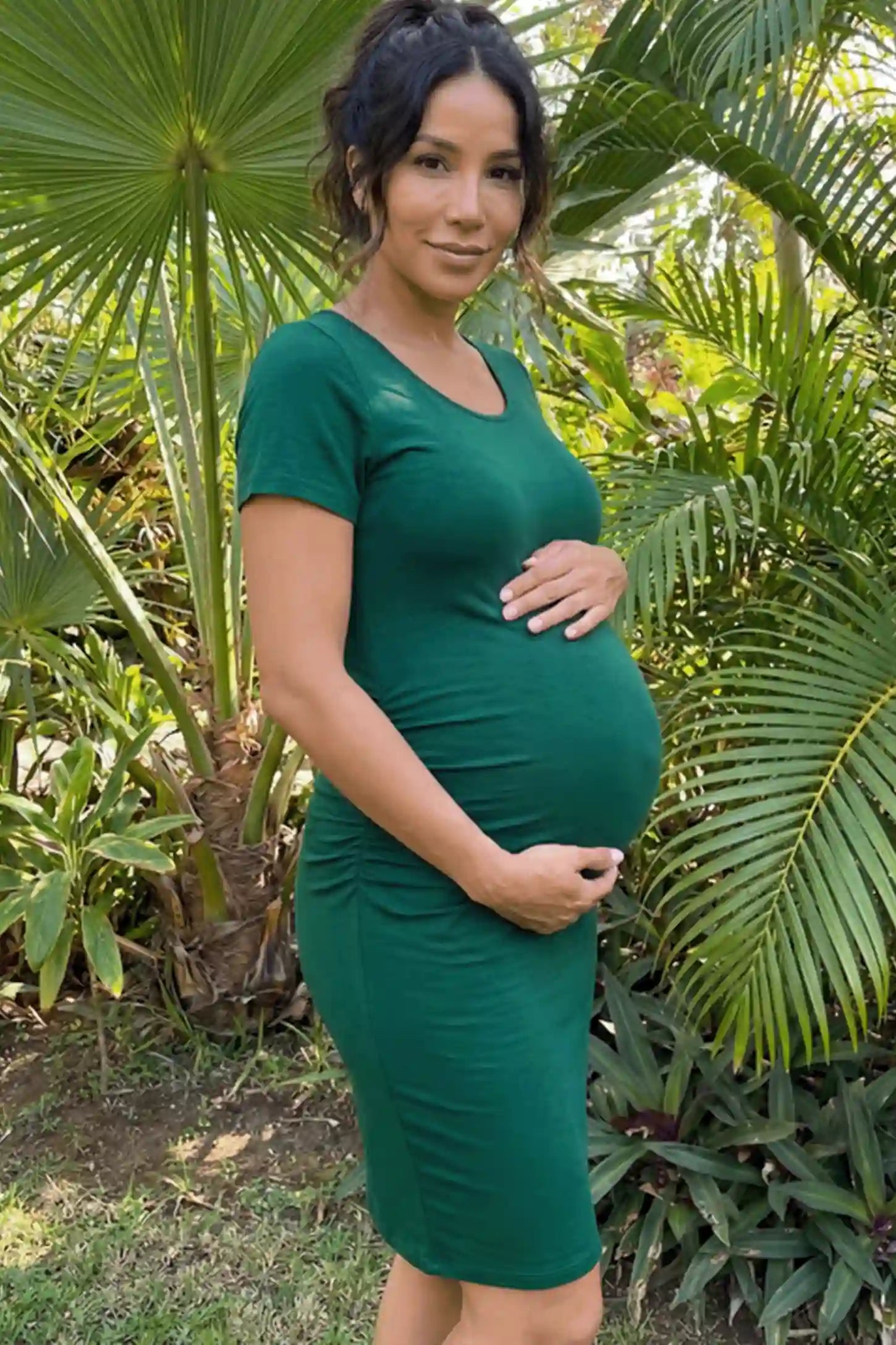 Ruched Side Scoop Neck Maternity Short Dress Ruched Side Scoop Neck Maternity Short Dress in Green featuring a form-fitting silhouette on a pregnant model.