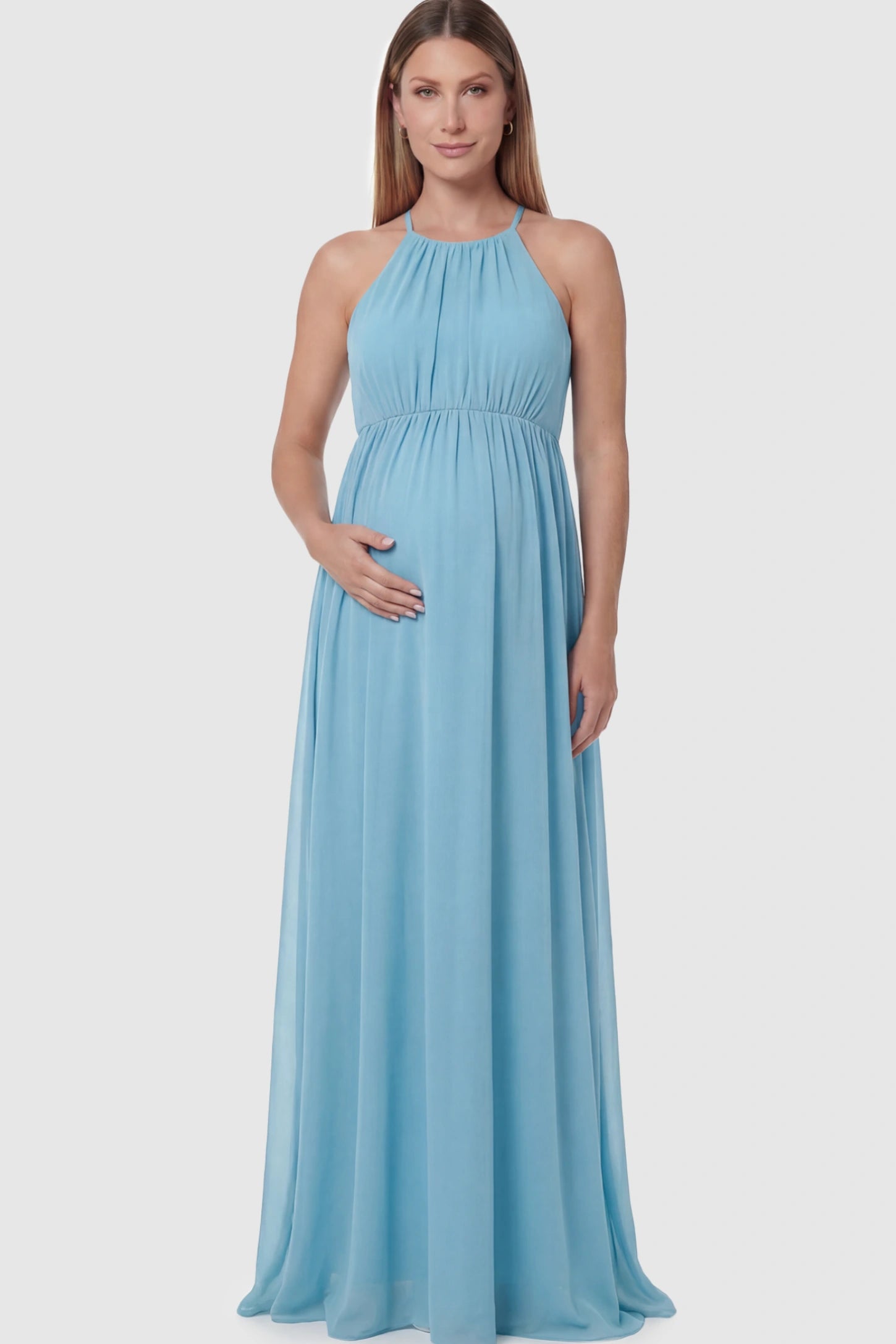 Pleated Mesh Sleeveless Maternity Photoshoot Dress Pleated Mesh Sleeveless Maternity Photoshoot Dress in Light Blue featuring a high-neckline and flowing skirt on a pregnant model.