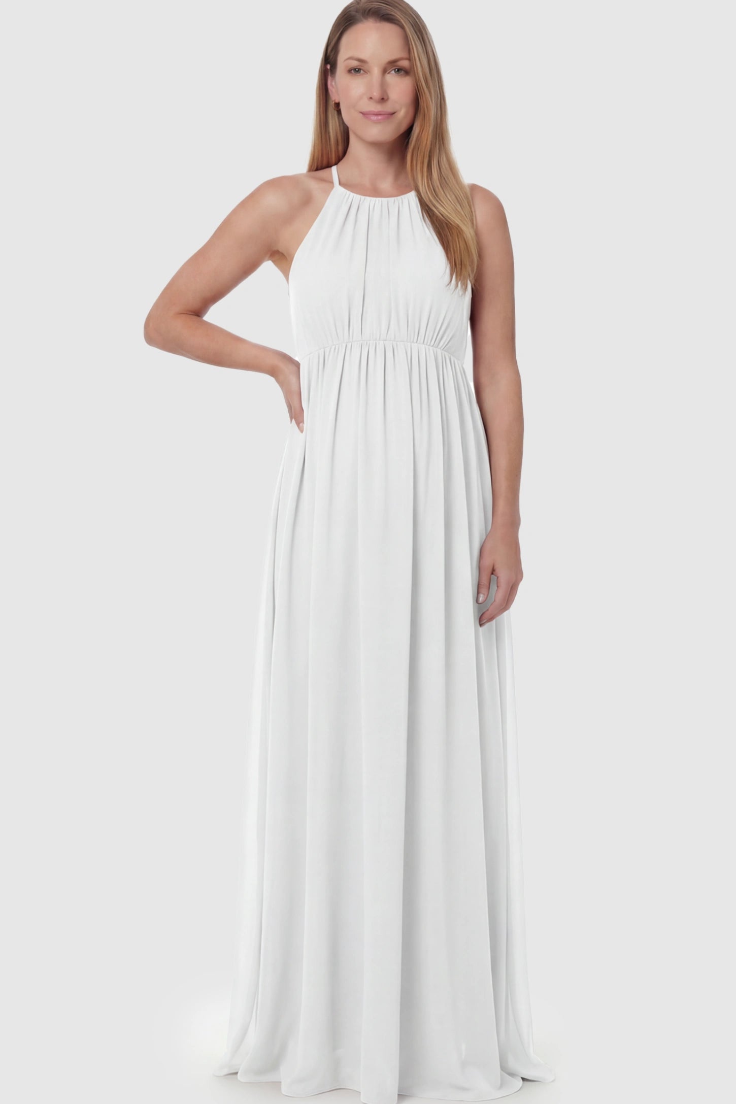 Pleated Mesh Sleeveless Maternity Photoshoot Dress Pleated Mesh Sleeveless Maternity Photoshoot Dress in White featuring a high-neckline and flowing skirt on a postpartum model.