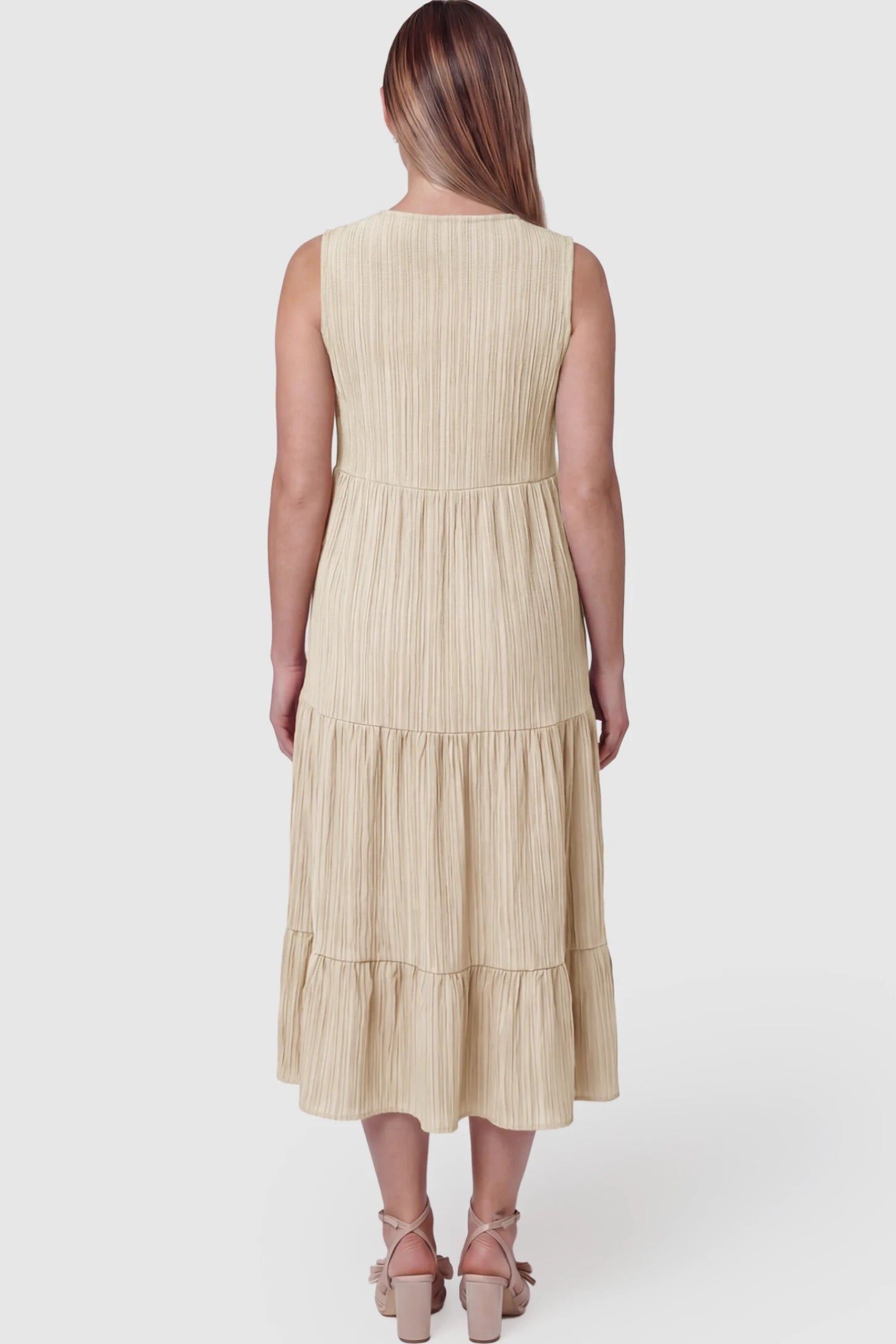 Solid Textured V-Neck Tiered Maternity Midi Dress Solid Textured V-Neck Tiered Maternity Midi Dress in Apricot featuring a high-waisted A-line silhouette on a pregnant model showing back.