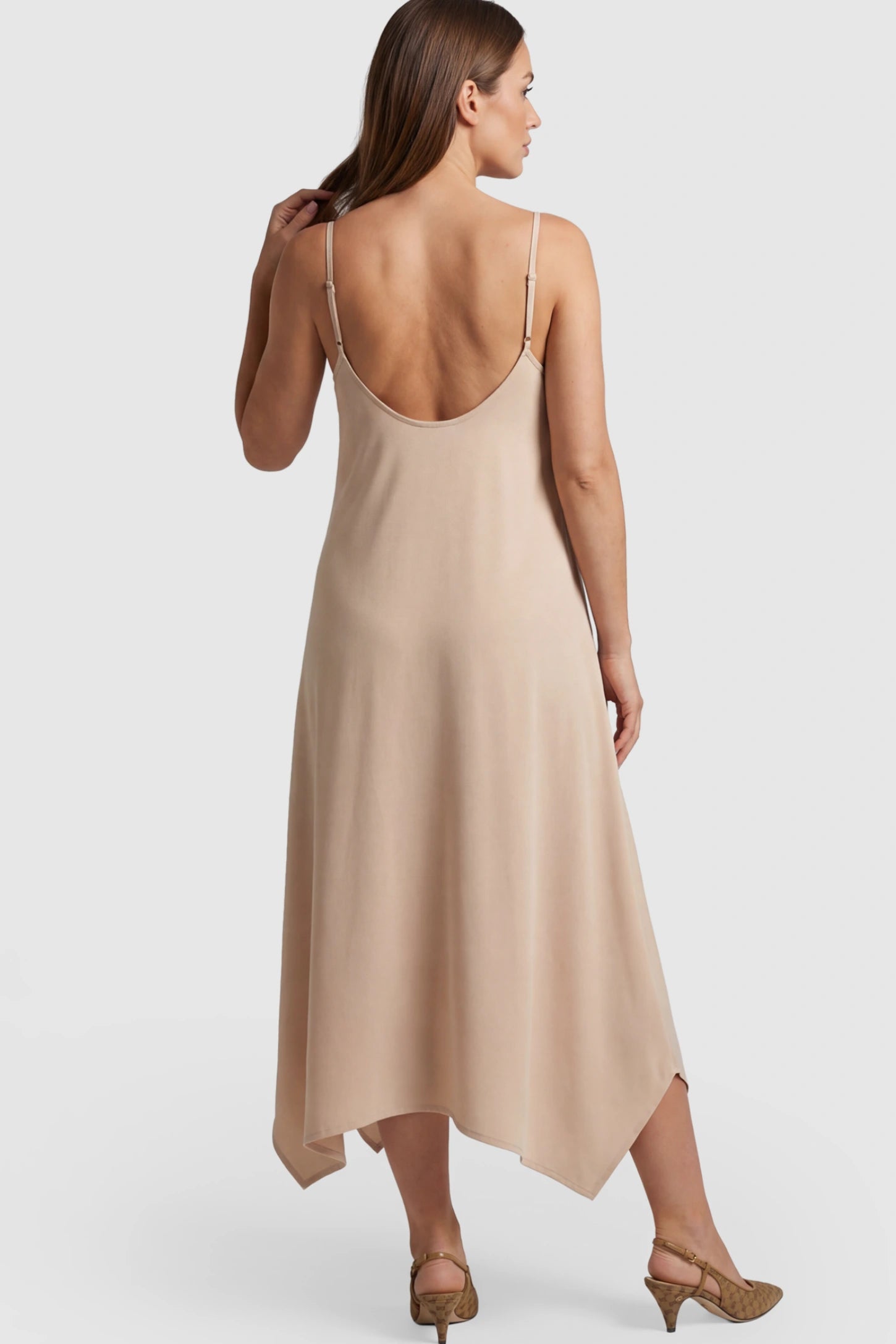 Spaghetti Strap Handkerchief Hem Maternity Midi Dress Spaghetti Strap Handkerchief Hem Maternity Midi Dress in Apricot on a pregnant model.