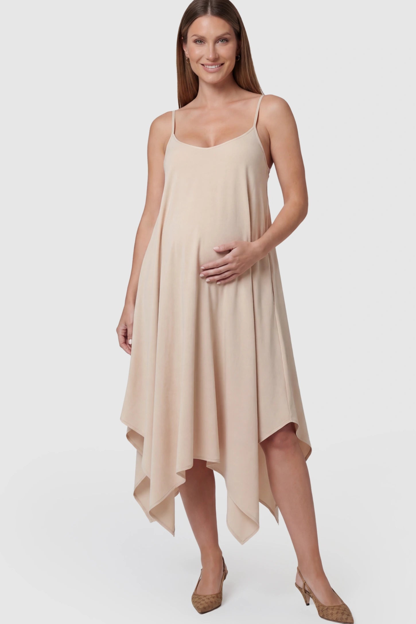 Spaghetti Strap Handkerchief Hem Maternity Midi Dress Spaghetti Strap Handkerchief Hem Maternity Midi Dress in Apricot featuring a scoop-neck on a pregnant model.