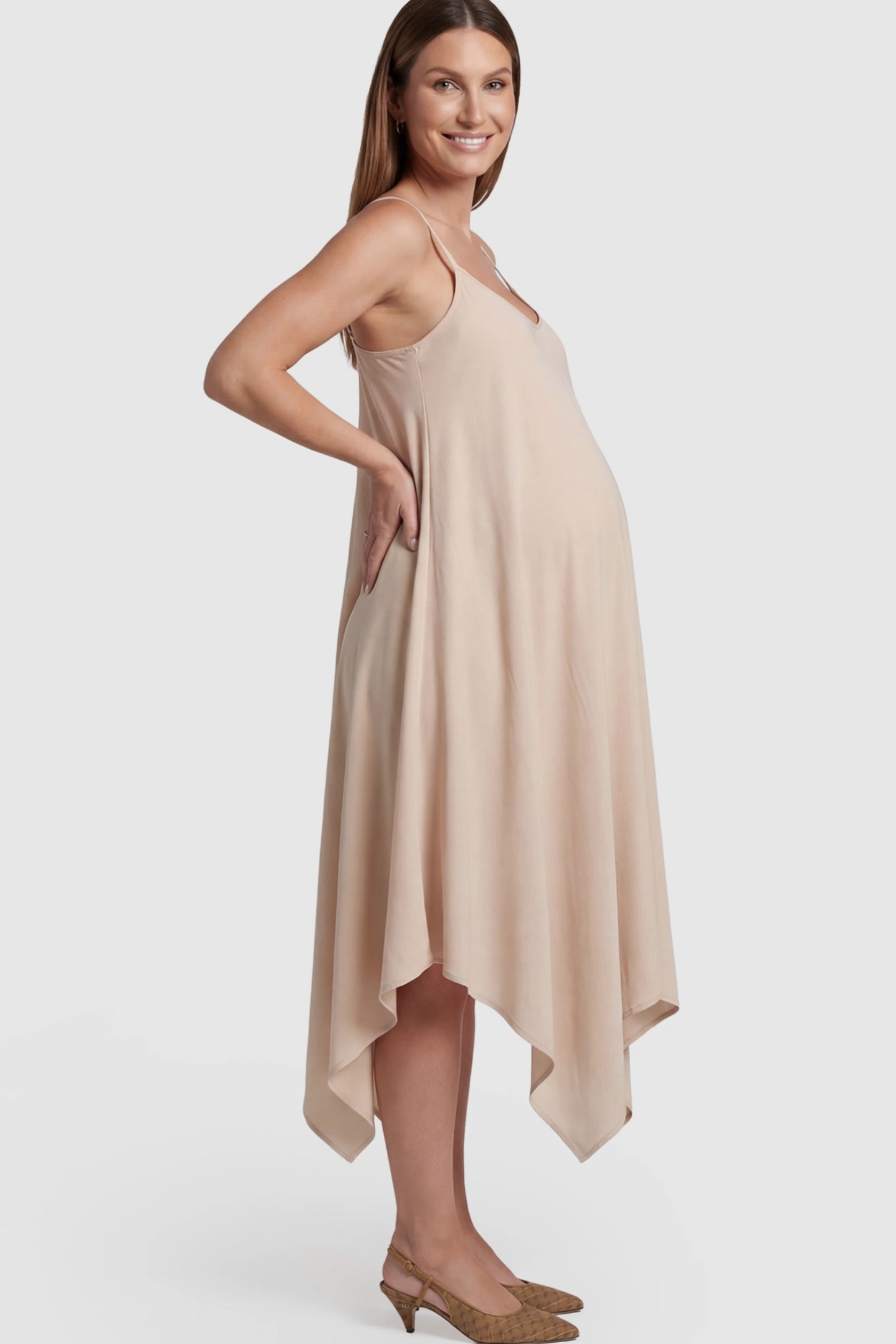 Spaghetti Strap Handkerchief Hem Maternity Midi Dress Spaghetti Strap Handkerchief Hem Maternity Midi Dress in Apricot featuring a scoop-neck on a pregnant model.