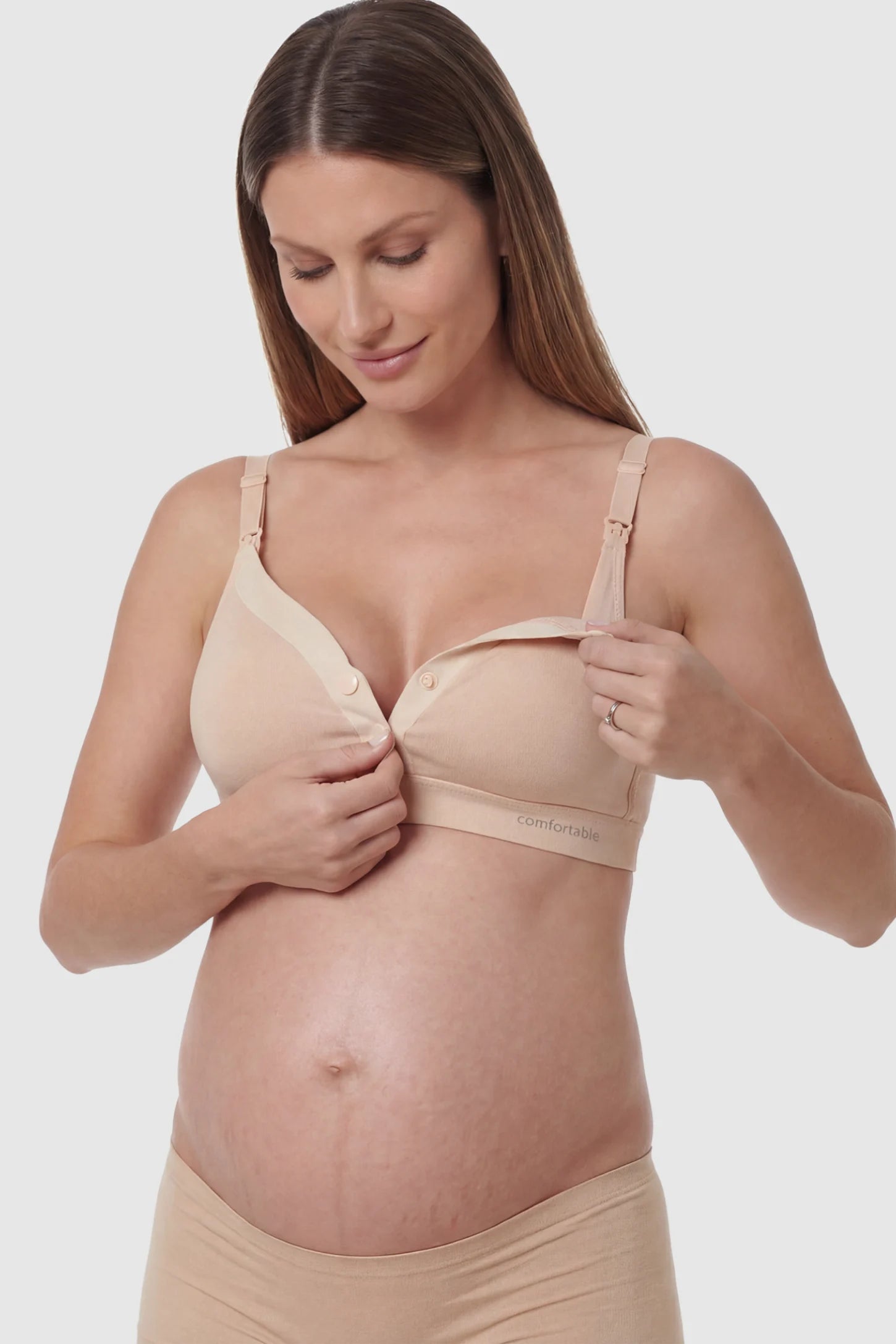 Soft Cotton Front Button Wireless Maternity Nursing Bra Soft Cotton Front-Button Wireless Maternity & Nursing Bra in Skin featuring snap-front access on a pregnant model.