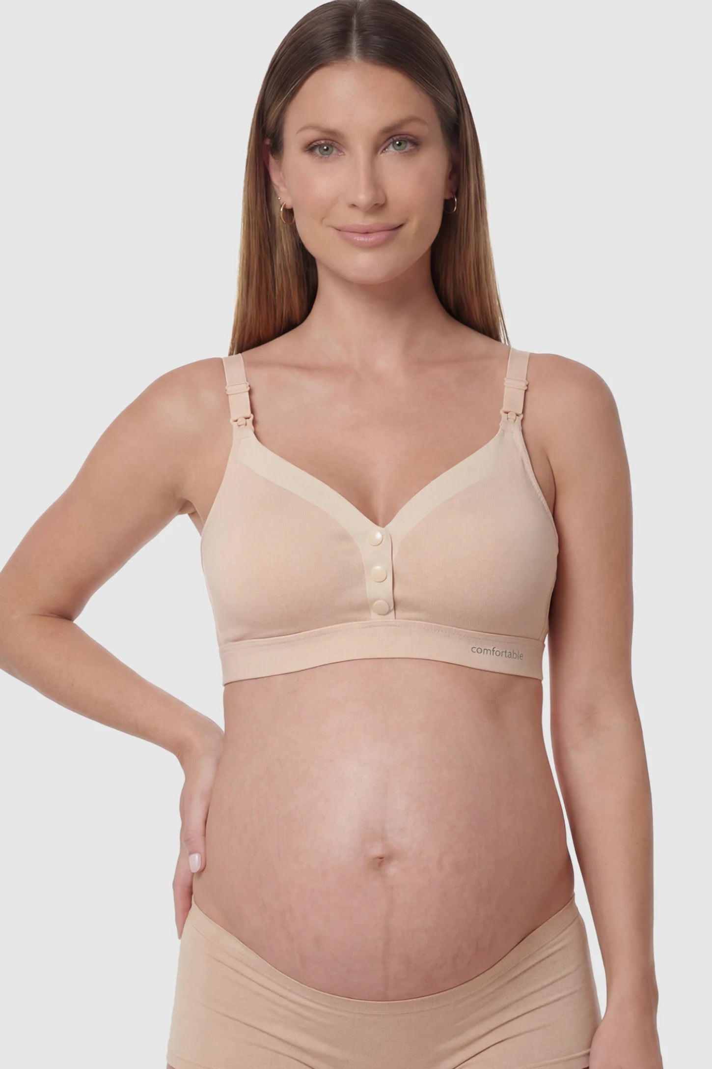 Soft Cotton Front Button Wireless Maternity Nursing Bra Soft Cotton Front-Button Wireless Maternity & Nursing Bra in Skin featuring snap-front access on a pregnant model.