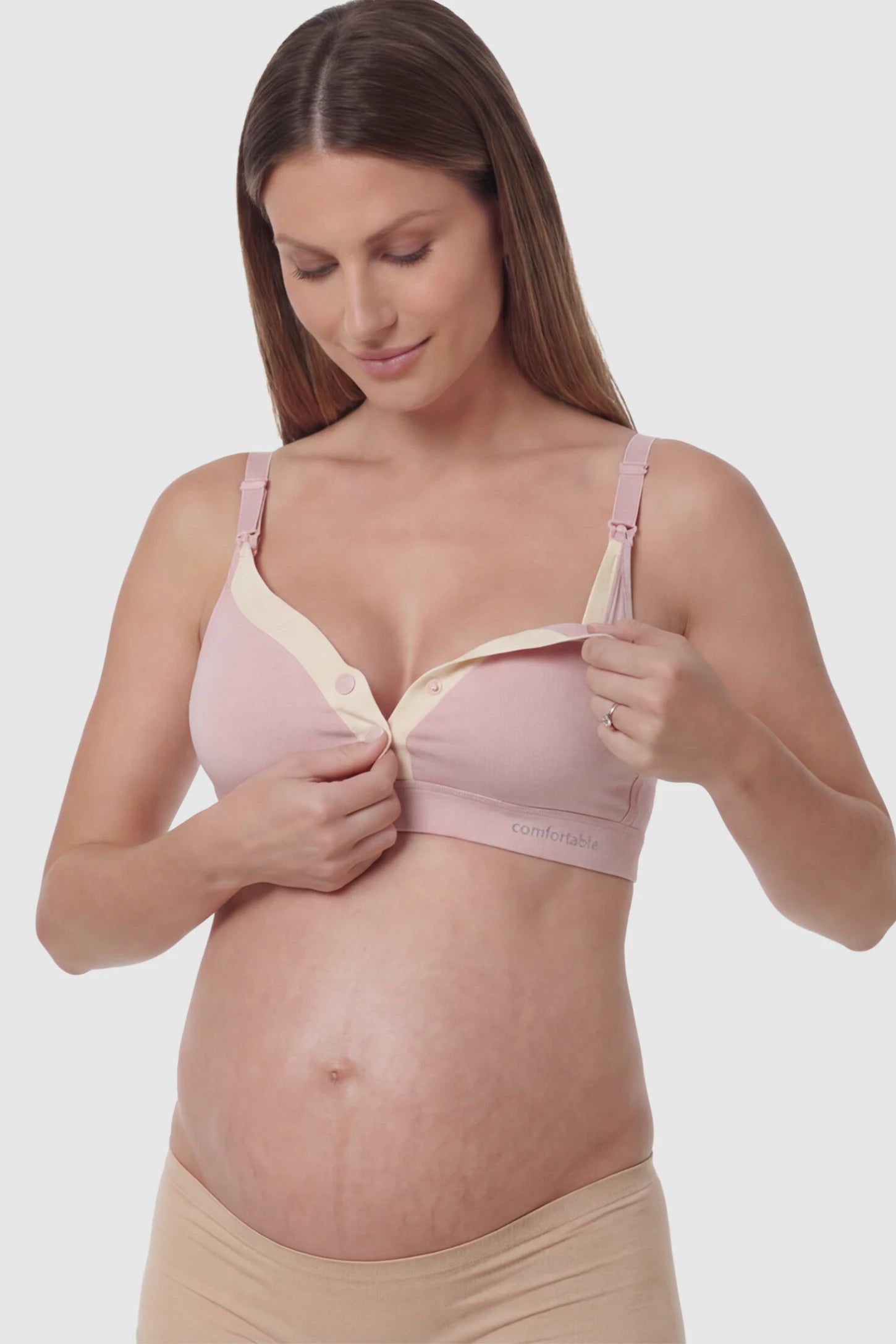 Soft Cotton Front Button Wireless Maternity Nursing Bra Soft Cotton Front-Button Wireless Maternity & Nursing Bra in Pink featuring snap-front access on a pregnant model.