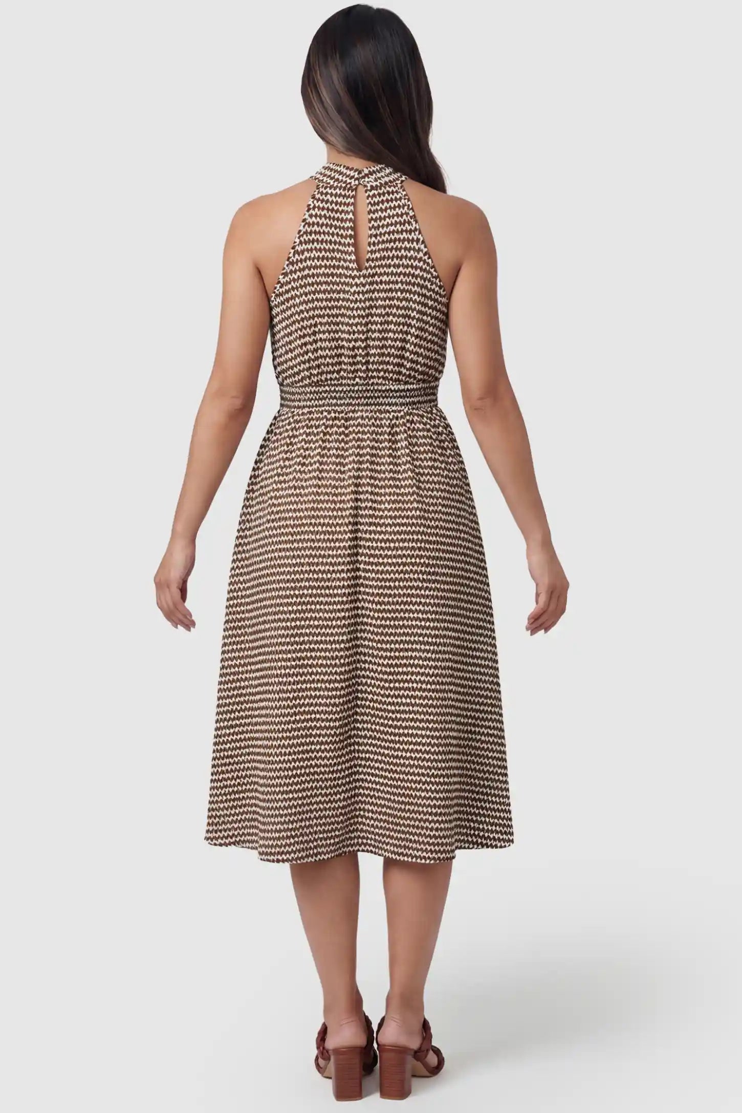 Patterned Print Halter Mock Neck Midi Maternity Dress Patterned Print Halter Mock Neck Midi Maternity Dress in Khaki featuring a keyhole detail on a pregnant model in back view.