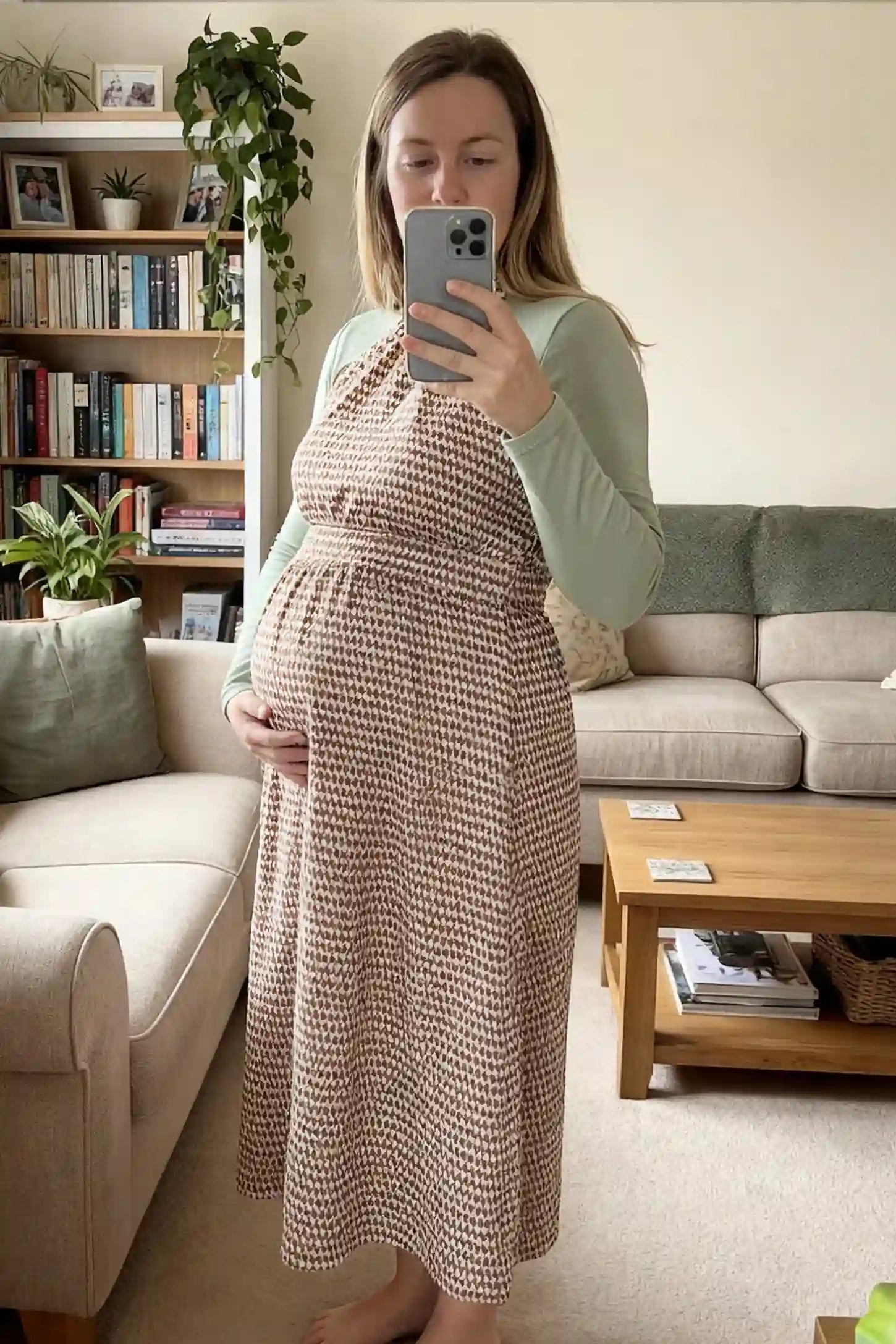 Patterned Print Halter Mock Neck Midi Maternity Dress Patterned Print Halter Mock Neck Midi Maternity Dress in Khaki featuring an A-line skirt on a pregnant model in front view.