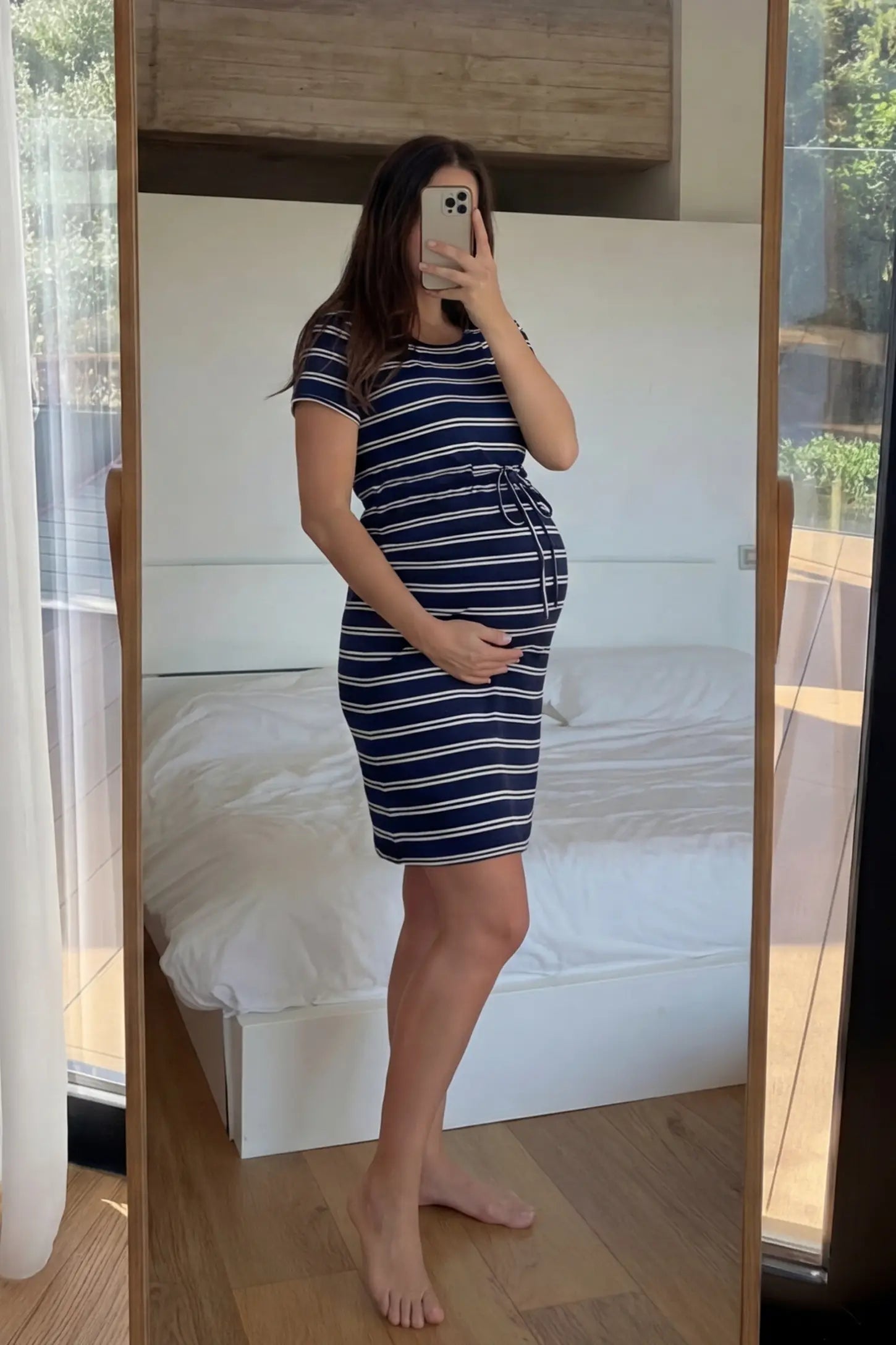 Nautical Striped Drawstring Waist Mini Maternity Dress Nautical Striped Drawstring Waist Mini Maternity Dress in dark blue and white featuring a round neckline on a pregnant model.