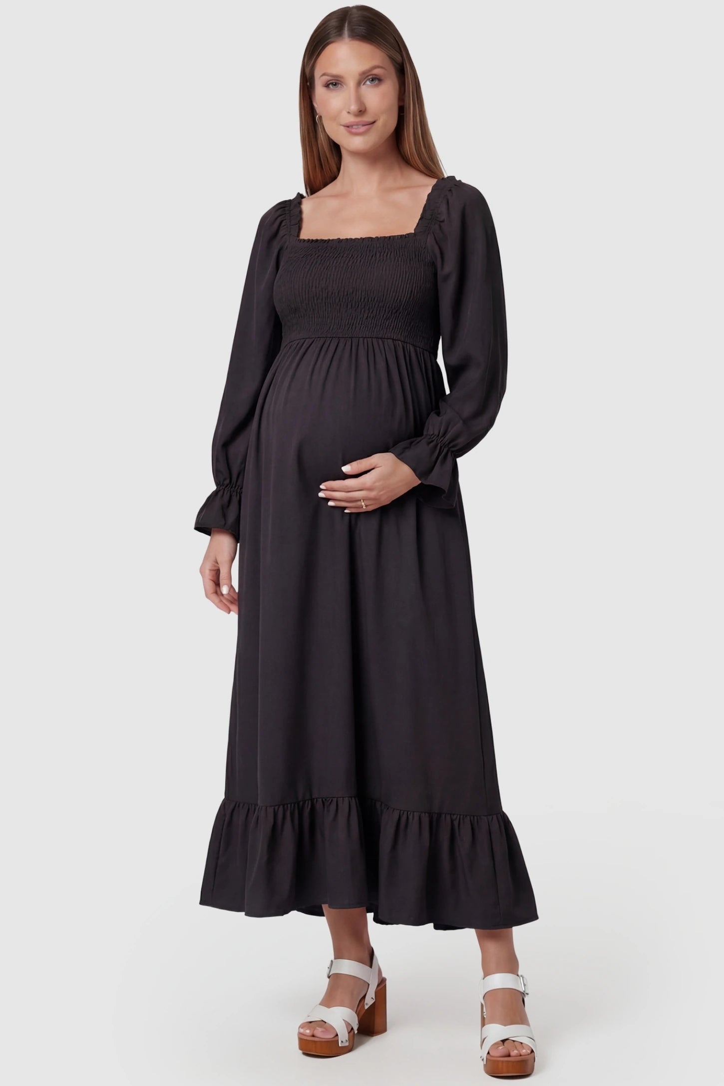 Solid Color Square Neck Ruffle Hem Midi Maternity Dress Black Square Neck Ruffle Hem Midi Maternity Dress featuring a smocked bodice on a pregnant model in a front view.