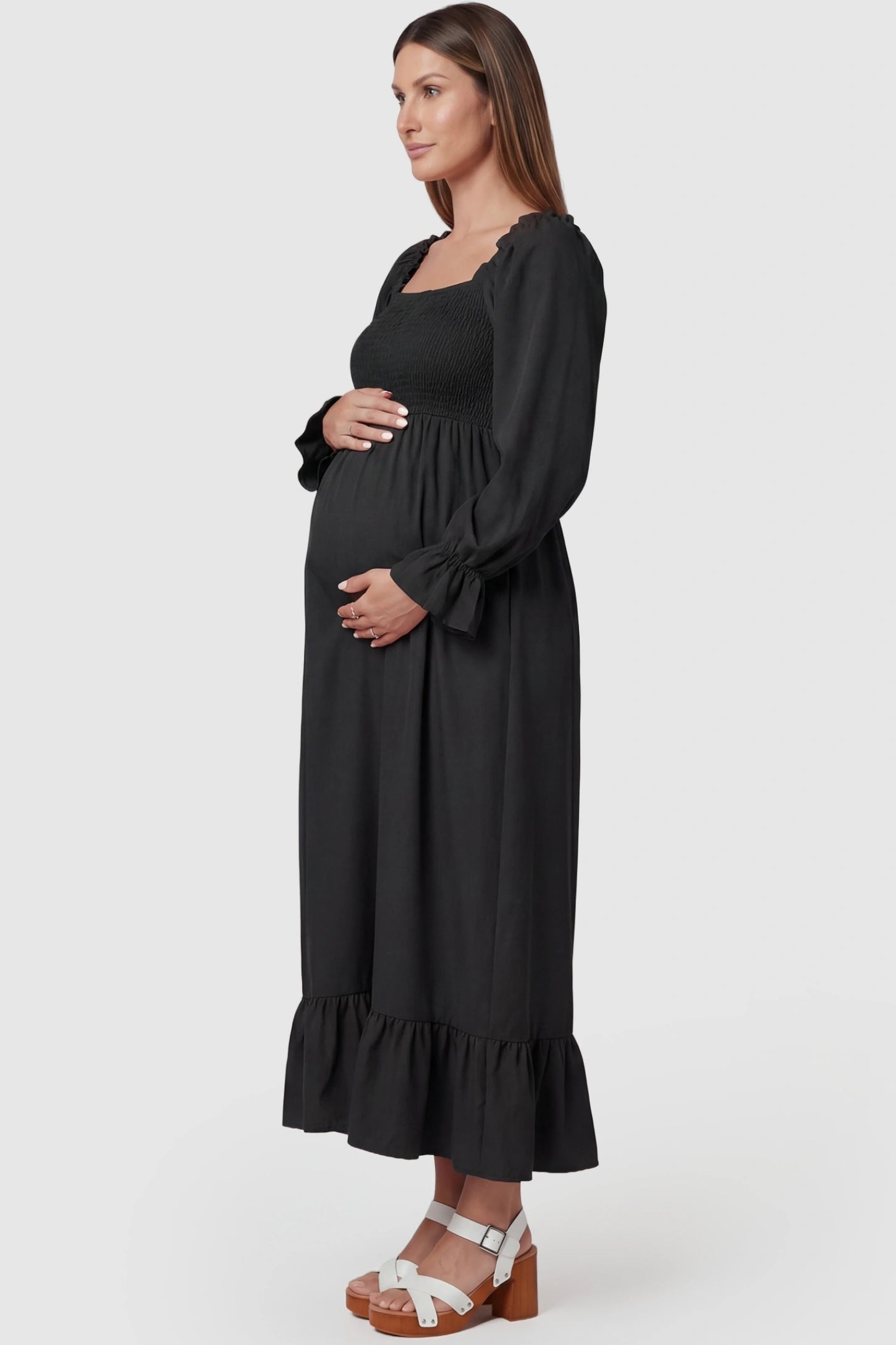 Solid Color Square Neck Ruffle Hem Midi Maternity Dress Black Square Neck Ruffle Hem Midi Maternity Dress featuring long puff sleeves on a pregnant model from a side profile.