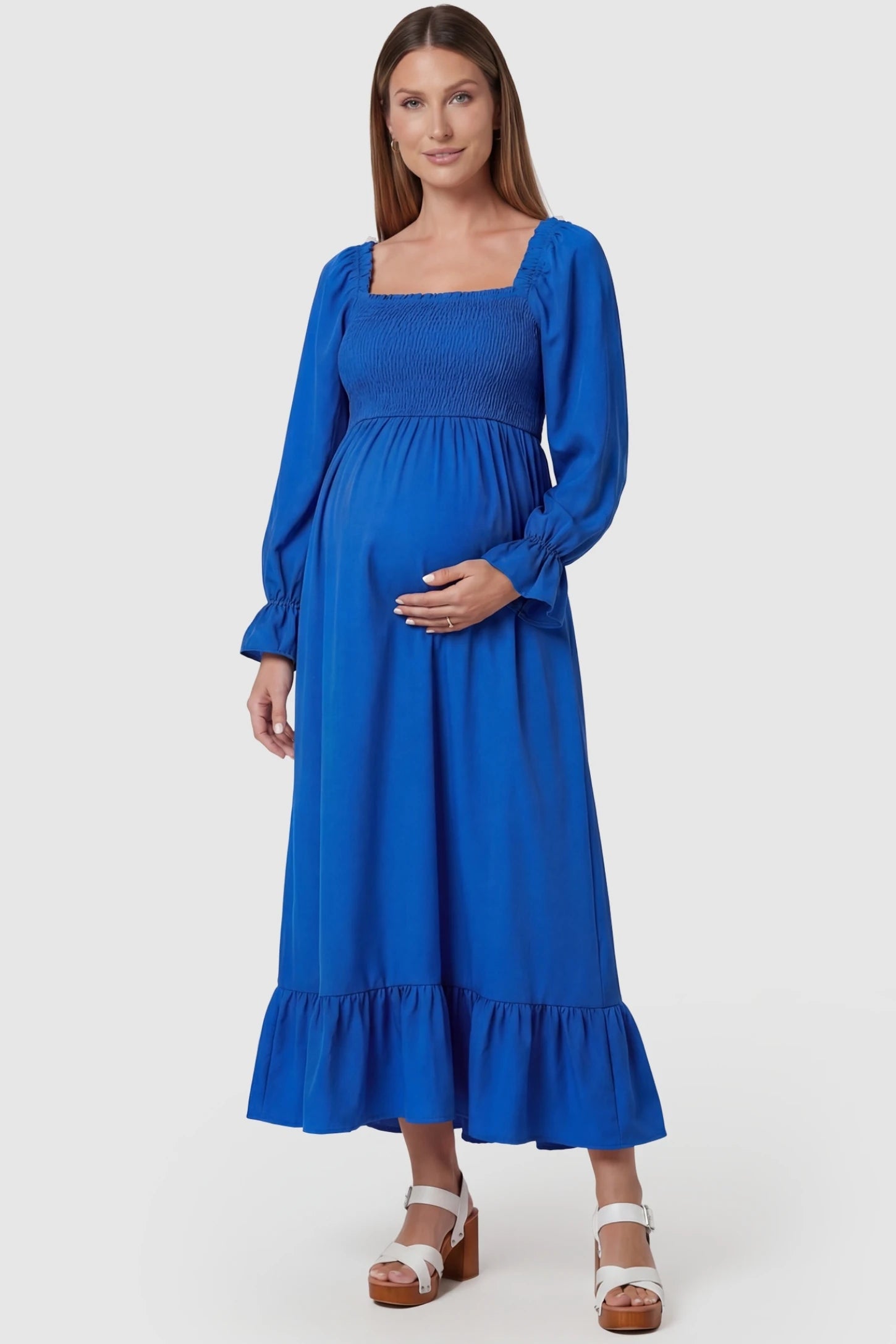 Solid Color Square Neck Ruffle Hem Midi Maternity Dress Blue Square Neck Ruffle Hem Midi Maternity Dress featuring a smocked bodice and A-line swing on a pregnant model, front view.