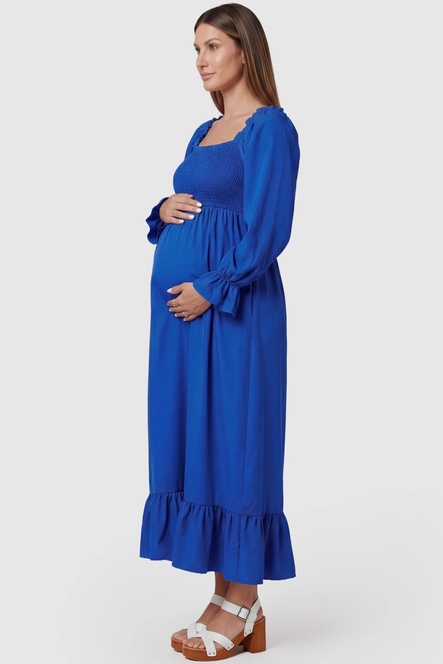 Solid Color Square Neck Ruffle Hem Midi Maternity Dress Blue Square Neck Ruffle Hem Midi Maternity Dress featuring long puff sleeves on a pregnant model in a side view.