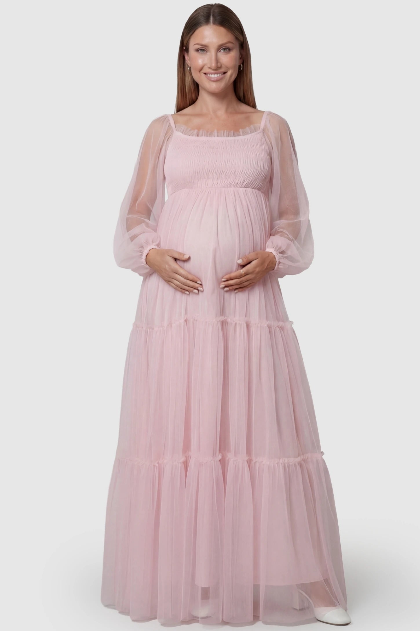 Tulle Lantern Sleeve Tiered Maternity Photoshoot Gown in Pink featuring a smocked bodice and front view on a pregnant model.