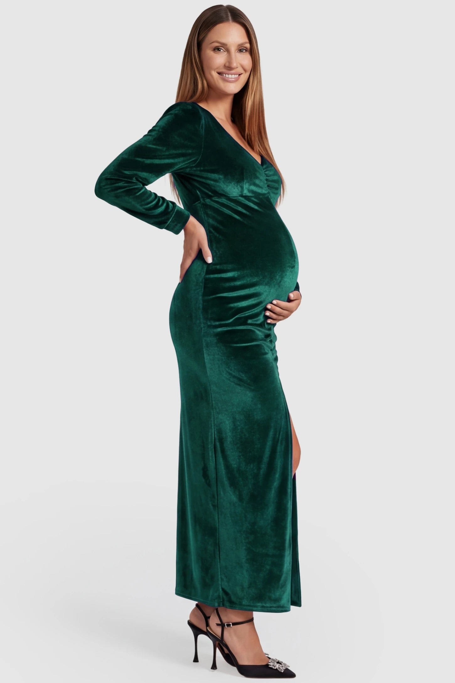 High Slit Velvet Pencil Cut Maternity Evening Dress High Slit Velvet Pencil Cut Maternity Evening Dress in Green featuring a thigh-high slit on a pregnant model, side view.