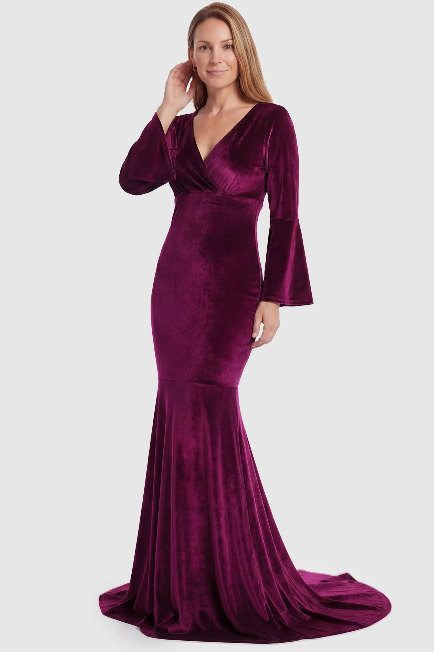 Velvet Long Bell Sleeve Maternity Mermaid Gown Velvet Long Bell Sleeve Maternity Mermaid Gown in Burgundy featuring a fitted waist on a non-pregnant model.