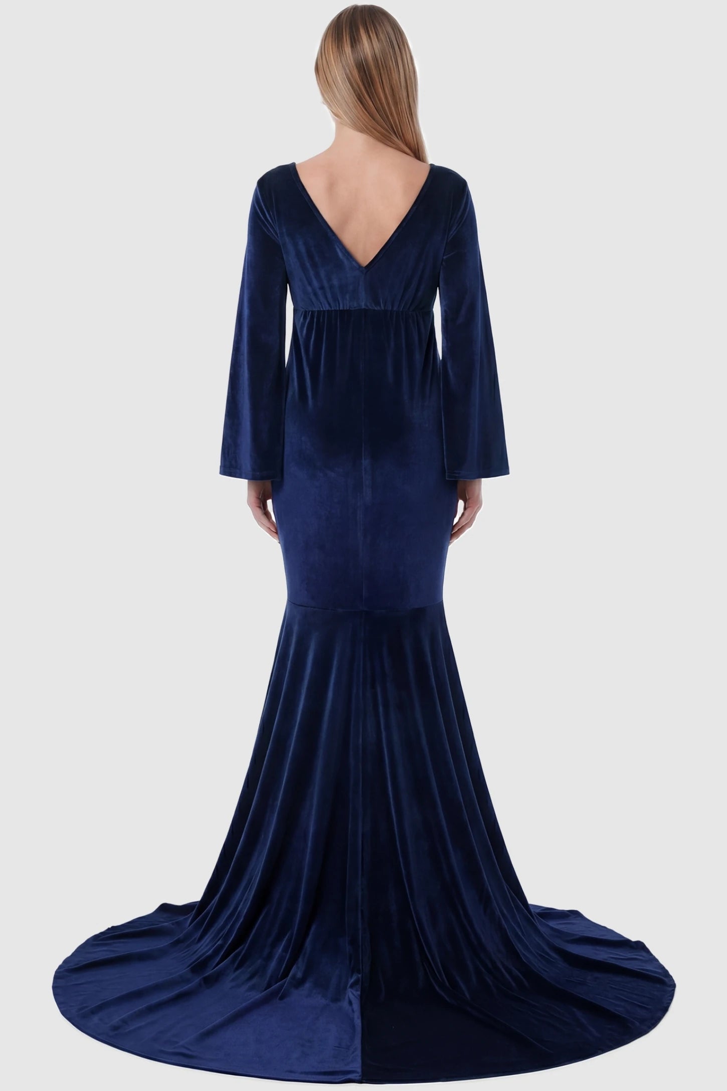 Velvet Long Bell Sleeve Maternity Mermaid Gown Velvet Long Bell Sleeve Maternity Mermaid Gown in Dark Blue featuring a V-neck back on a pregnant model.