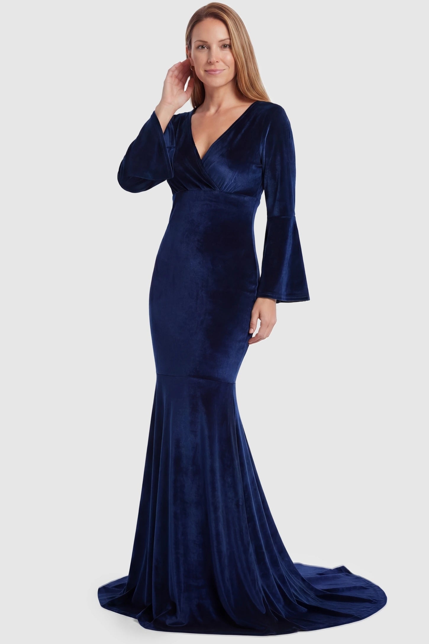Velvet Long Bell Sleeve Maternity Mermaid Gown Velvet Long Bell Sleeve Maternity Mermaid Gown in Dark Blue featuring a fitted waist on a non-pregnant model.